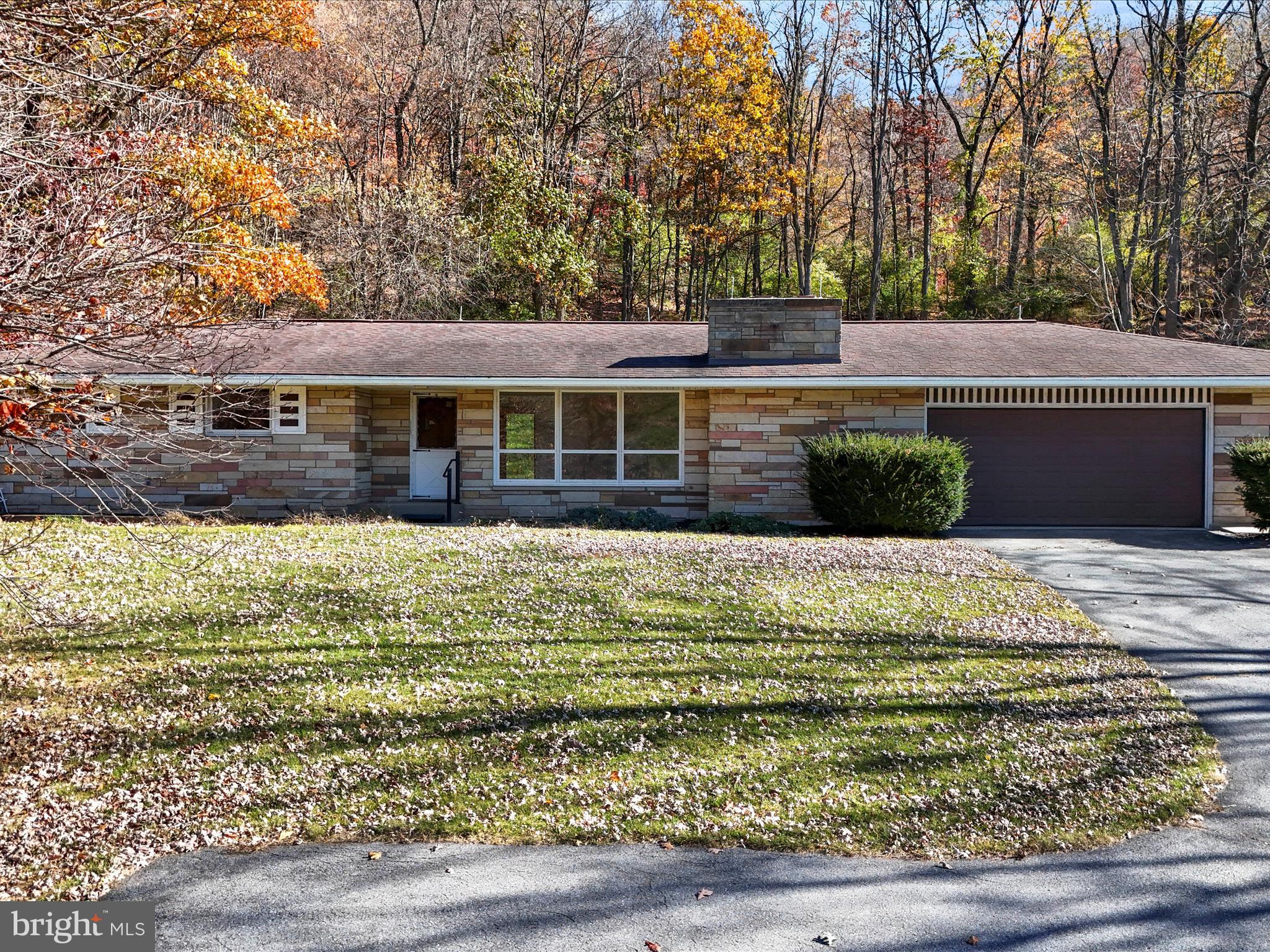 Welcome to your dream retreat nestled in the serene mountains! This charming ranch-style home, built in 1968, boasts a timeless stone exterior and a spacious 1.8-acre lot, offering a perfect blend of comfort and nature. Step inside to discover a warm and inviting interior featuring three cozy bedrooms and two full bathrooms. The galley kitchen is equipped with an electric oven/range, making meal prep a delight, while the dining area is perfect for gatherings. Enjoy the ambiance of two beautiful brick fireplaces, ideal for cozy evenings. The partially carpeted and vinyl flooring throughout adds a touch of warmth, and the insulated windows ensure a peaceful atmosphere. The full basement, with an outside entrance, provides ample storage and laundry space, while the attic offers additional potential. Let's not forget the 30 X 50 ft detached garage which can house up to 8 cars! Outside, you'll find an expansive yard and panoramic views of the mountains and trees, creating a tranquil oasis. With no pool to maintain, you can spend your time enjoying the natural beauty surrounding you. This home is not just a property; it's a lifestyle. Experience the perfect blend of comfort, convenience, and breathtaking views in this inviting mountain retreat. Don’t miss the opportunity to make this your forever home! Price has also been reduced!!