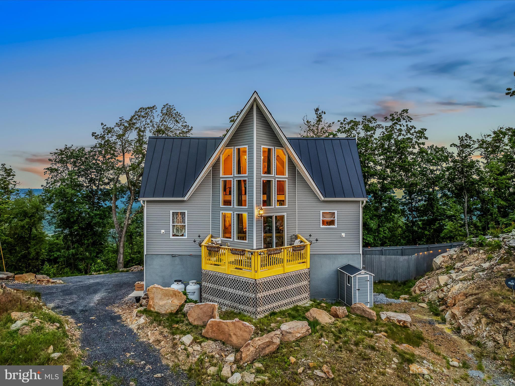 "Perched Above It All – A Rare Mountain Retreat on 10 Acres"
Welcome to a one-of-a-kind mountaintop oasis that truly feels like you’re living on top of the world. This stunning property offers breathtaking views in every direction and combines sustainable living with timeless elegance. Set on 10 expansive acres, this home is an extraordinary opportunity for anyone looking to embrace self-sufficient living without sacrificing modern comfort.
Step inside to discover hardwood floors flowing through most of the home, setting the stage for a warm, natural ambiance. The well-appointed kitchen is not only functional but perfectly positioned to enjoy panoramic views over the rolling countryside—cooking here is a pleasure, not a chore.
The spa-like primary bathroom is your own personal retreat, featuring a walk-in tiled shower and a show-stopping claw foot tub that invites you to relax in style. Upstairs, an extraordinary seating area offers a front-row seat to the surrounding landscape—whether you're enjoying a quiet moment or entertaining guests, you’ll feel truly above it all.
The property also boasts a large, productive greenhouse that has yielded an impressive variety of vegetables and herbs—ideal for anyone interested in gardening or homesteading. With solar panels, an onsite septic system, and a private well, this home offers exceptional cost efficiency and environmental stewardship.
Whether you're seeking a full-time residence or a peaceful second home, this unique property blends natural beauty, thoughtful design, and energy-conscious living. It’s not just a home—it’s a lifestyle.