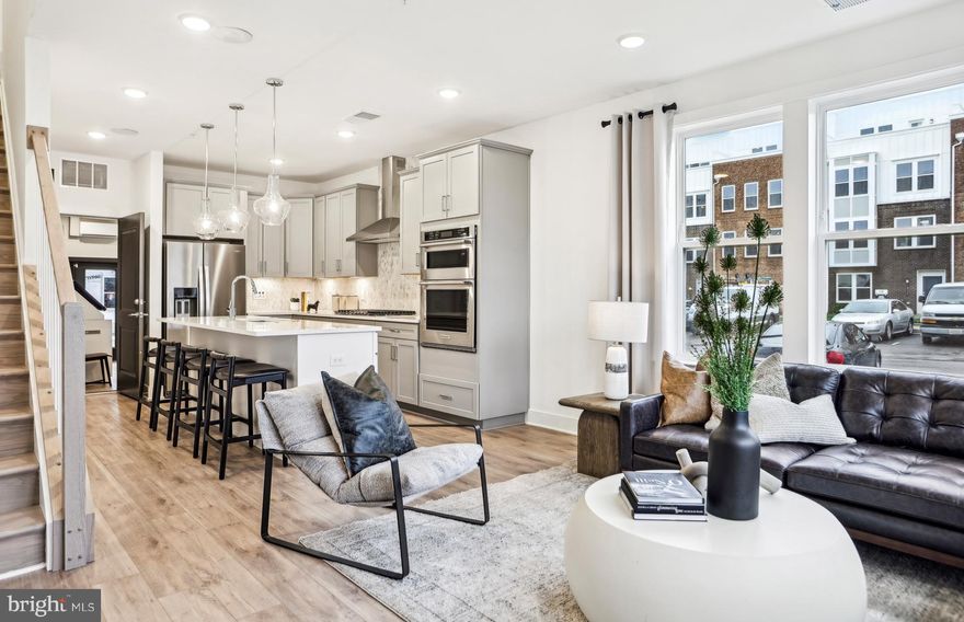 This Lower Level Lawrence condo offers 3 Bedrooms, 2.5 Bathrooms, a 1-Car Garage & a 1-Car Driveway. As you enter the open floorplan home, the Gathering room has 3 windows. The Gourmet Kitchen is spacious and is complete with a large island with Quartz Countertops and Cabinets. This home includes KitchenAid Appliances with a 5-Burner Gas Cooktop, Chimney Hood Vent and a Microwave/Oven Combination. The large walk-in pantry is very convenient as you enter the home from the garage. The Owner’s Suite is spacious boasting sizable dual walk-in closets. The Owner's Bath has a dual vanity sinks, a walk-in shower with a seat, a separate water closet, and a linen closet.  Off the Owner’s Suite, is a 6’ x 20’ Balcony to enjoy a morning coffee or an evening cocktail.  A convenient walk-in laundry room and a linen closet to complete the second floor. There are 7" Luxury Vinyl Plank(LVP) on the 1st Floor.  Oak stairs from first to second floor is included.