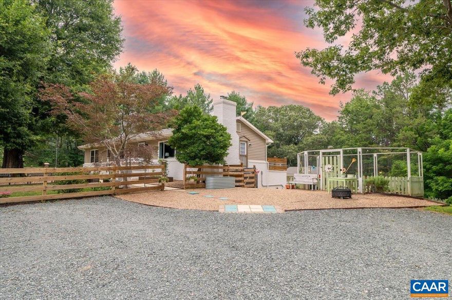 Enjoy the perfect blend of country living and modern comfort in this 4-bedroom, 3-bath home set on 2+ scenic acres. A newly graveled drive welcomes you to a private retreat featuring two primary bedrooms (Upstairs & Downstairs) and a fully finished walk-out lower level?ideal for guests or multi-generational living.  The kitchen features granite countertops, stainless appliances, a gas range with custom hood, Bosch dishwasher, LG refrigerator and an 1860 Empire kitchen buffet that conveys. In the living room you'll find a La Nordica Rosa XXL wood-burning cook stove/oven.   Major systems include a Trane hybrid heat pump, Bradford White gas water heater, and Generac whole-house generator for year-round peace of mind.  Outdoors, enjoy a fenced yard, two deer-proof gardens, mature landscaping, peach trees, and a spacious deck. A climate-controlled outbuilding with 50-amp electric adds flexibility for a workshop or studio.   Located only 15 minutes from Hollymead Town Center! Don't miss this home!,Granite Counter,White Cabinets,Fireplace in Living Room