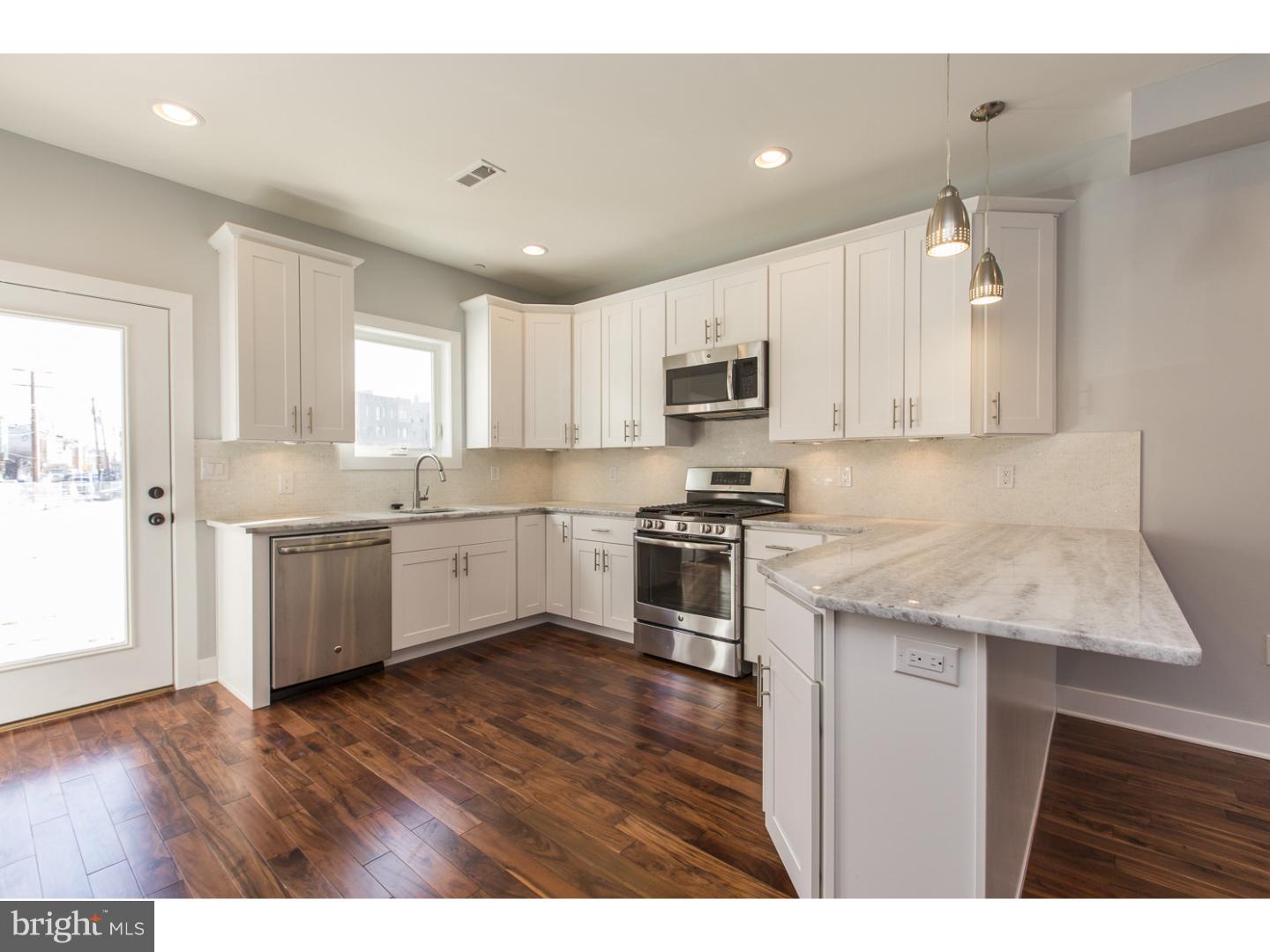 Contemporary luxury and sophisticated style unite effortlessly in this brand new Northern Liberties residence with parking that you'll love to call home! One of eight homes comprising the new community called NL8, this place dazzles with hardwood flooring, recessed lighting, high ceilings, eye-catching aesthetic details, and oversized windows for abundant natural light throughout. Enter into your bright, inviting living and dining space that is sure to impress your guests. Pull up to the breakfast bar and admire the gourmet kitchen showcasing granite countertops, stainless steel appliances, 42" cabinetry, and pendant lighting. Out the back door, it's just a moment's walk to the parking lot housing your own private spot. Back inside, head upstairs and discover two lovely bedrooms with large closets, a beautiful hall bath with custom tiled tub/shower combo, and your upper floor laundry room. Up one more flight to the master suite, boasting his and hers walk-in closets and a spa-like bath featuring a double vanity and an opulent walk-in shower with frameless glass door and dual shower heads. Now, step out onto your fiberglass rooftop deck and take in the stunning skyline views! Still hoping for a home office or media room? The finished basement offers carpeted space accompanied by another convenient full bathroom. On top of all this, you'll enjoy a video intercom system and an energy efficient HVAC system, plus there's a 10-year tax abatement pending! You'll walk to all the beloved Northern Liberties establishments: restaurants, bars, entertainment venues, parks, you name it. Plus, you're moments from transit and major roadways! Schedule your tour today, and get ready to experience a whole new lifestyle!