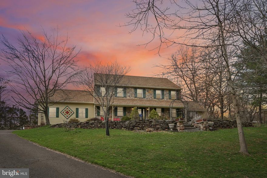 Beautiful stone-front Colonial offering 4 bedrooms and 2½ baths, ideally situated on a picturesque half-acre lot at the end of a cul-de-sac. A dramatic two-story family room welcomes you inside, complemented by spacious living and dining rooms featuring elegant trim work. The open-concept kitchen and family room create a warm and inviting space for everyday living and entertaining. The eat-in kitchen is beautifully appointed with granite countertops, a large island, generous pantry, recessed lighting, and striking mosaic tile. Gorgeous hardwood floors, refinished in 2023, run throughout most of the first floor.
A stunning office or great room features bamboo flooring, a cathedral ceiling, and lots of windows that fill the space with natural light. The main level also includes a well-designed mudroom with built-ins and a convenient powder room. Upstairs, the primary suite offers an ensuite bath and a walk-in closet with custom built-ins, along with additional closet space. Three additional generously sized bedrooms share a beautifully updated hall bath. A large laundry room plus a versatile bonus room/craft room provide endless possibilities for a playroom, home gym, or additional office space. The outdoor setting is truly special. Enjoy the inviting front porch overlooking terraced garden beds, while the private backyard features a spacious deck accessible from both the kitchen and family room—perfect for relaxing or entertaining. The yard also includes thoughtfully designed garden areas, a raised-bed vegetable garden and plenty of space for enjoying the outdoors. Additional updates include HVAC and A/C replacement in 2022, new refrigerator, stove, washer, and dryer in 2024, and seamless gutters installed in 2024. Located in the highly regarded Central Bucks School District, this home offers a wonderful cul-de-sac location with convenient access to restaurants, shopping and major routes.