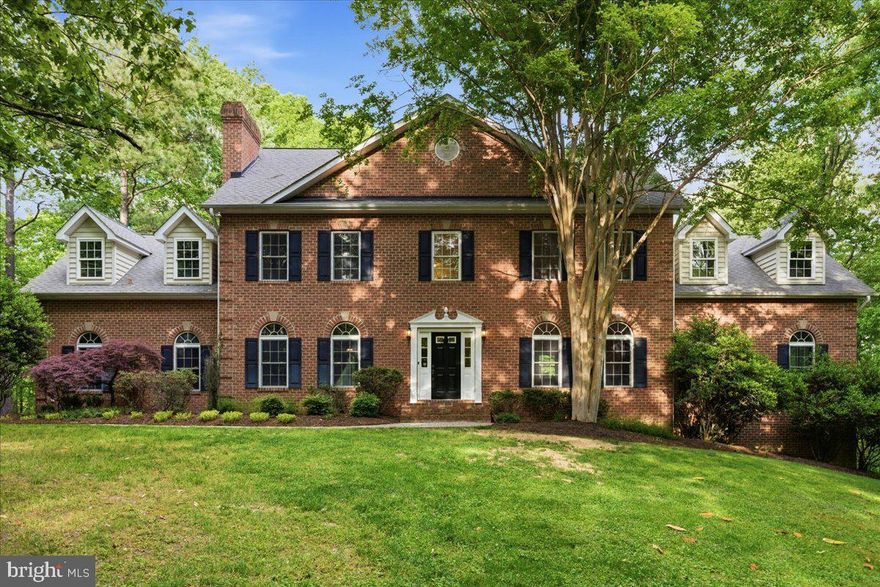 Luxury home on 5 private wooded acres in sought-after Calvert County, Maryland with Chesapeake Bay boating access. Bordered by 121 acres of protected community open space, this property offers rare privacy, natural views, and resort-style amenities.

The oversized kitchen features solid cherry cabinetry and expansive prep space ideal for entertaining. Main level includes a dramatic second family room with soaring ceilings and abundant natural light.

Upper-level primary suite retreat with gas fireplace, sitting area, dual walk-in closets, and spacious bath. Convenient upper-level laundry with direct primary suite access.

Finished walk-out lower level includes theater room, custom bar crafted from on-site wood, secondary kitchenette, and fitness or hobby room.

Outdoor living features a heated 9-ft deep gunite pool with diving rock and fountain. Underground sprinkler system for yard. Community marina and boat ramp on Saint Leonard Creek off the Patuxent River for boating, fishing, and waterfront recreation.

Private acreage. Luxury features. Southern Maryland lifestyle.