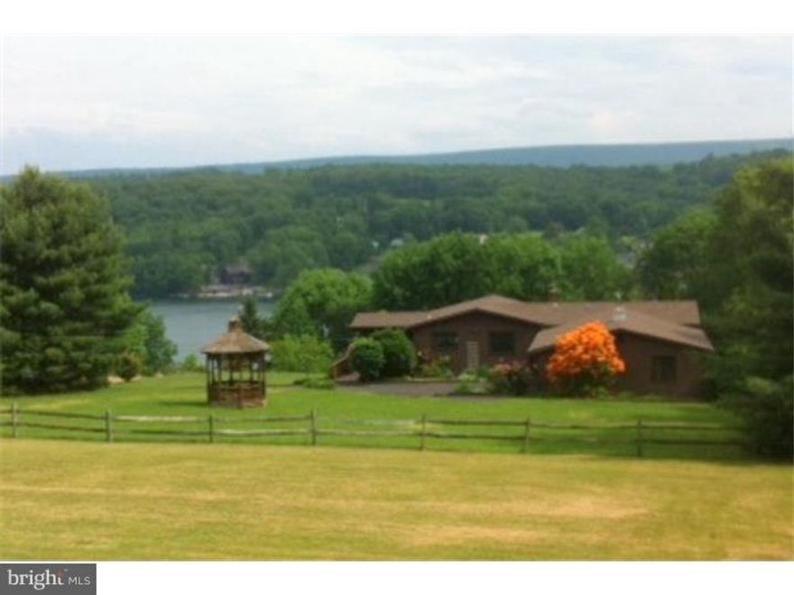 Panoramic Views of Lake and Mountain Side, on Corner Property. Wrap-Around 40-foot Deck, Heated 2-Car Garage, Paved Driveway, Wall-to-Wall Carpet, Recessed Lighting, Lower Level Storage Rooms. New Deck & Roof. Capped Pipe for Laundry in Half-Bath.