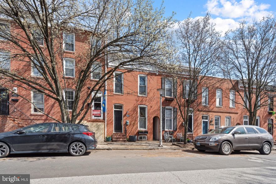 Welcome to 1417 Battery Avenue, nestled in the vibrant heart of Federal Hill! This meticulously maintained 2-bedroom, 2.5-bath rowhome showcases refined living space, complete with an expansive parking pad. Step inside to discover gleaming original wood floors complementing a generous open-plan layout, seamlessly merging into a gourmet kitchen adorned with stainless steel appliances, granite countertops, a wine fridge, and ample cabinetry. The main level also hosts a separate dining area and a half bath. Ascend to the second floor to discover a lavish primary suite featuring a spa-like bathroom with a jetted tub, separate shower, and dual vanity. The second bedroom is at the rear of the house and offers a private balcony.  Convenience is key with laundry located on the second floor. Enjoy entertaining on your large rooftop deck and soak up the panoramic views of the city.
Enjoy all the city has to offer as you're blocks from Cross Street market, Riverside Park, and Fed Hill Park plus it's a quick ride to I-95