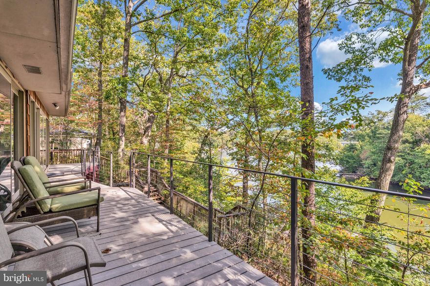 Winner Disney's Sweet Retreats, 4120 sq ft waterfront home, 100' floor to ceiling windows-decks w/ water views nestled in tree canopy 65' above Weems Creek.  LL has 16' wide sliding glass doors to large fieldstone patio w/ 2nd pond & waterfall. Steps down to the 40' floating dock w/40' fixed pier,12K lb boat lift. Minutes to USNA & City Dock. Add'l 8500 sq ft avail for home expansion! views are A+