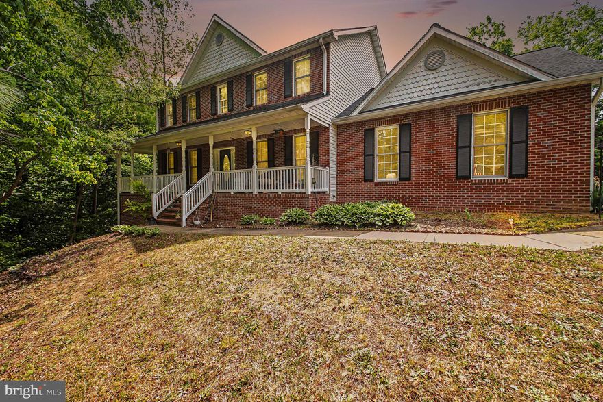 **Ask about our aggressive buyer incentives**
Welcome to this spacious colonial-style home filled with charm, functionality, and endless potential. A welcoming front porch sets the tone as you step inside to discover a thoughtfully designed layout offering generous living spaces throughout. The main level features a large formal dining room accented with elegant chair rail molding, a separate sitting room perfect for a home office or additional living space, and an expansive family room highlighted by a cozy gas fireplace. The family room flows seamlessly into the kitchen and breakfast nook, creating the ideal setup for everyday living and entertaining alike.

The kitchen offers an abundance of cabinet space, granite countertops, ample prep space, and a functional layout designed for both convenience and gathering. Just off the kitchen, the breakfast nook overlooks the private, tree-lined backyard, while the adjacent deck provides the perfect place to relax, dine outdoors, or enjoy peaceful wooded views. A convenient main-level laundry room and oversized two-car garage add both practicality and storage.

Upstairs, you’ll find four generously sized bedrooms, including a spacious primary suite complete with a walk-in closet and private en-suite bath featuring dual vanities, a soaking tub, and separate shower. The additional bedrooms offer flexibility for family, guests, or work-from-home needs and are served by a well-appointed hall bath.

The unfinished walkout basement provides even more living space with incredible versatility—perfect for a recreation room, gym, media space, playroom, or future guest suite. With abundant square footage, functional spaces, and room to make it your own, this home presents an exceptional opportunity in a beautiful setting.

Ideally situated for both convenience and commuting, this home provides easy access to Dahlgren Base, Fort Belvoir, and is just a short drive from Downtown Fredericksburg’s shopping, dining, and entertainment.