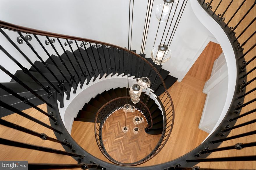 Once a grand 19th-century brick mansion, this Gilded Age Princeton original has undergone an
extraordinary metamorphosis at the hands of design visionary Bela Rossmann of Polo Design
Build. Reimagined from top to bottom, the home is now a tour de force of 21st-century
modernism layered over old-world craftsmanship. Rossmann’s reworking doesn’t erase the
past, it enhances it. What was once formal is now fluid, and what was once historic is now
timeless. Original woodwork is preserved alongside striking new elements like flat-panel walnut
cabinetry, custom Italian lighting, and bold marble accents. In the redesigned kitchen, solid
walnut drawers glide under striking quartz counters and a Sub-Zero suite anchors the space,
while an 8-burner Wolf range presides beneath a sleek hood. A central hall with herringbone
floors and timeless circular stairs with bespoke custom-designed 14 glass pendants beneath a
leaded glass skylight gives way to a paneled library and den with hidden shelving and a bright,
elegant dining room. The former ballroom now serves as a vaulted-ceiling great room, with
multiple seating arrangements allowing the space to be comfortable for a small gathering or a
grand entertainment space, that opens to two garden spaces, one featuring a brick courtyard
with the other, redesigned gardens and lawn edged in clipped Hawthorne tree hedges. There
are eight fireplaces and 14 separate climate zones, making comfort as customizable as the
design. The primary suite is nothing short of a private wellness retreat, complete with two
spa-like bathrooms, a marble-clad tub room, a shower room with an oversized shower controlled
by an electronic keypad, heated floors, and a dressing room worthy of a fashion editorial. Four
additional bedrooms include two guest suites and a pair of mirror-image bedrooms connected
by a Jack-and-Jill bath. A sunny multipurpose room with exposed brick and skylights serves as
this home’s kick-back-and-relax space near a handy second staircase leading to an organized mudroom and the heated two-car garage. Every detail has been touched, yet the soul of this
home remains intact. An impeccable vision and design executed to the Nth degree.