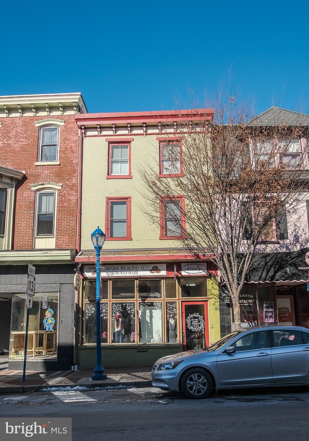 What an opportunity to rent an AMAZING  prime storefront or office space on the 200 Block of Bridge Street! Right in the middle of everything, you will find this stunning, sun-drenched space adorned with beautiful hardwood flooring and 12ft  high decorative copper ceilings .  The private entrance leads to a large front-space with huge display window is wide open and visible to the many cars and passers-by.  Marketing your business will be easy with this large window space. The rear area features a separate enclosed area currently fitted-out for a kitchen.  A quick walk down the hallway and you will find a shared bathroom and breakroom area. This space is perfect for many types of commercial or retail uses including light food use. Downtown Phoenixville is hopping ALL YEAR ROUND! With 10,000+ cars per day driving right past this building, plus so many patrons visiting the many restaurants, pubs, shops and Colonial Theater,  you will have year-round foot traffic. This location is shown by appointment only. Don't miss out on your chance to get your dream business started in the heart of Downtown Phoenixville. Please note that listing pictures are from a previous tenant.