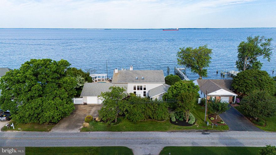 Location !!! This home offers exceptional bay front frontage in one of the most desired communities on Kent Island, Queen Anne Colony! From the pristine Sunsets to swimming in the pool while taking in the bay air and not to mention the fishing off the dock! The home offers a dock with a boat lift and two jet ski lifts. Enjoy your own sandy beach depending on the time of day.  With 4300 Square feet there is plenty of space for entertaining and sleeping.  Some of the bedrooms offer a walk out deck overlooking the bay.