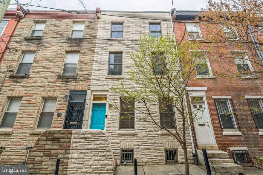 Located on a quiet, tree-lined block in Philadelphia's coveted Rittenhouse Square neighborhood sits 1532 Naudain St., a beautifully maintained and recently updated 3-story townhome with 3 beds, a den and 2 full baths. The main level boasts a spacious kitchen with stainless steel appliances, ample counter space, and a peninsula with stool seating. The bright living and dining room offers newly refinished hardwood floors and a brick fireplace with a gas insert. The serene backyard garden is your private oasis for grilling or planting a container garden. On the second level, there’s a bonus space ideal for an office or den, while the primary suite includes a walk-in closet and a modern bathroom with designer tile, a floating vanity, and an glass-enclosed shower. The top floor offers a second full bedroom with closet, a full brand new bathroom with hunter green subway tile, a modern wooden vanity with storage and a large linen closet. The third sunlit bedroom is spacious with a full closet as well. The dry unfinished basement includes laundry and plenty of storage. Located just steps from Rittenhouse Square, the Avenue of the Arts, and top restaurants, this home has a Walk Score of 100 and easy access to public transit, Broad St, Center City, and major hospitals. Schedule a tour today!