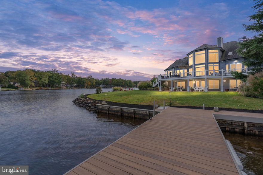 **Experience Waterfront Living at Its Finest**

Welcome to your dream waterfront home, where everyday life transforms into a serene escape filled with adventure and relaxation. Nestled on a prime point lot within a gated lake community, this stunning property offers not just a home, but a lifestyle enriched by the beauty of nature and the joys of lake living.

As you pull into the circular driveway, you're greeted by a charming front porch, providing a perfect spot to unwind while taking in the spectacular water views. Picture yourself sipping morning coffee as the sun rises over the lake.

Step inside, and you’ll find an inviting interior designed for both comfort and functionality. The spacious kitchen, outfitted with quartz countertops and stainless-steel appliances, is not just for cooking; it’s the heart of your home where family and friends gather to share meals and create lasting memories. Imagine preparing a delicious meal while sharing laughs and stories, with the beautiful lake serving as your backdrop.

The adjacent sunroom is your personal retreat, offering panoramic views of the water and inviting natural light to fill the space. It’s the perfect spot for reading a book or simply enjoying the tranquility of the lake. And when you’re ready for some fun, step outside to your own backyard paradise.

With a private dock just steps away, you have immediate access to a world of water activities. Whether it’s launching your kayak for a peaceful paddle across the glassy surface, gathering friends for a fun day of boating, or trying your hand at paddle boarding, the lake is your playground. Imagine spending sun-soaked afternoons gliding across the water, exploring hidden coves, or simply floating in the sunshine, surrounded by nature’s beauty.

After a day filled with outdoor fun, gather around the fire pit on your own private beach while taking in the sunset over tranquil lake.

Inside, the great room features a floor-to-ceiling fireplace that creates an inviting ambiance for relaxation. The soaring walls of windows offer unforgettable lake views.

The primary bedroom is your personal sanctuary, with direct access to the deck overlooking the water. Imagine waking up to the sounds of nature and the sight of the sun glistening on the lake, inviting you to step outside and start your day surrounded by beauty.

Upstairs, a spacious bonus room awaits, ready to accommodate your lifestyle needs, plus two additional bedrooms & baths. Plenty of space for the entire family! The lower level features an enormous rec room for family fun, two bedrooms, bath and exercise room! This home truly has it all!

Located in the sought-after Lake of the Woods community, you’ll have access to a wealth of amenities, including a clubhouse, golf course, community center, and recreational courts. Enjoy leisurely strolls along the lakeshore, participate in community events, or simply bask in the joy of living in a vibrant neighborhood filled with friendly faces.

This waterfront home offers a unique opportunity to embrace a lifestyle where every day feels like a vacation. Come tour today!