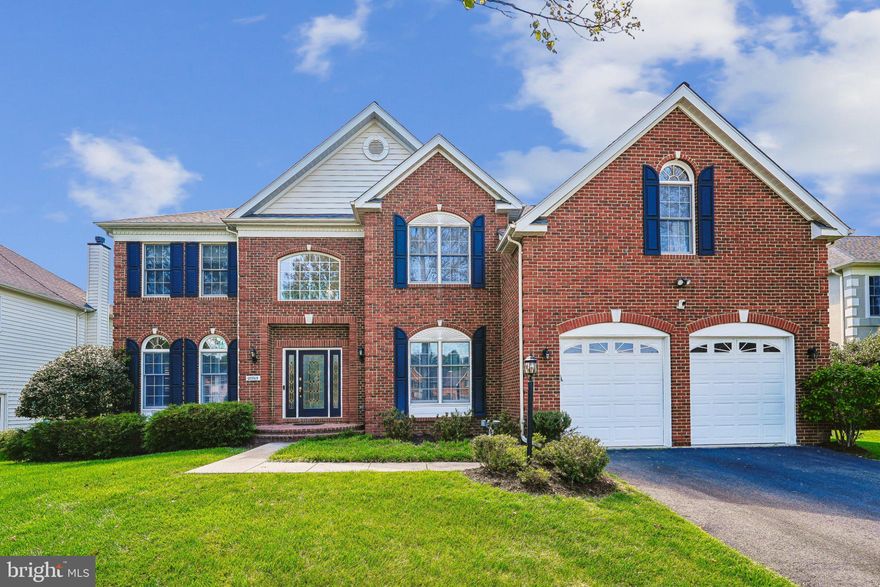 Sought after, South Riding!  Harvard Model with over 5300 square feet of living space with Solar Panels! Lot size is over a 1/4 acre that has a large private natural tree area in the backyard for a secluded fire pit for relaxing "in the woods"!  This home has great curb appeal with a  welcoming brick front, two story foyer and gorgeous hardwood floors. First floor Office for easy access and quiet. Dual Stairways! The elegant hardwood stairs in the foyer overlook the entrance and leads to the Bedroom Level. The formal Living Room and separate Dining Room have elegant bay windows, crown molding and architectural columns for a decorating edge. The Kitchen is a cook's delight, with double ovens, white cabinetry, large island with cooktop, beautiful granite counters, pantry and is large enough for a kitchen table for casual dining.  Just off kitchen is the full sunroom with a wall of windows and entrance to the Composite deck and rear yard.  The two story Oversized Family Room has enough room for comfortable seating and entertaining.  The Family room has an additional wall of windows that offer natural lighting and a wood burning fireplace that lead up the second, of dual, stairways to the Bedroom level.  The Primary Bedroom with the sitting room has two walk in closets.  Primary bathroom with two separate vanities, separate shower and tub has plenty of space.  Down the hall are two bedrooms that share a dual entry full bath, and  the Princess suite has their own ensuite bath.  On the lower level is a den/bedroom with access to a full bath, a rec room, study areas, exercise/ flex space, media/game room, Granite counter with wet bar included!  
New Roof, very well maintained, Solar Panels -2021, HVAC 2015, Kitchen Ovens 2020. Recessed Lights throughout, Solar Panels installed by Palmetto Solar and paid off.   South Riding has many amenities and schools are nearby!  No need to leave the neighborhood!