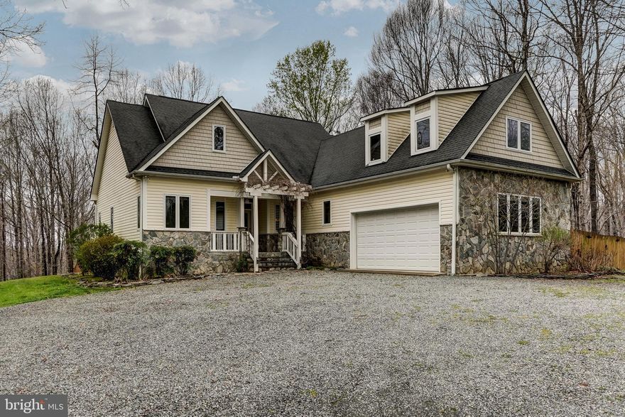 Beautiful custom-built craftsman style home with  200ft of water frontage on the South Anna River. Split bedroom design, open floor plan featuring oak & post beam, and beautiful hardwood flooring throughout. 4 bedrooms, 2 baths (3 bedroom septic) and 2,188 finished Sqft of living space. Family room showcases vaulted ceilings and a stone wood burning fireplace that is open to the dining area and eat-in kitchen that has custom cabinetry, two under-counter wine refrigerators, center island and breakfast bar. Main level primary ensuite features a tray ceiling, door to back deck, walk-in closet, double vanities, garden tub and a separate tile shower. Two other bedrooms, a full bath and laundry room complete the main level. Upstairs you'll find a large bonus room that could be used as a 4th bedroom, home office, or living area. Tankless water heater, whole house is wired for stereo system (includes back deck), has central vacuum and the Generac generator conveys! Large back deck, screen porch, 2 car attached garage with built in workbench & shelving and a 16x16 barn/shed for storage. There is a cleared path to the river and a cleared area at the river frontage. Cul-de-sac location and situated on 5.92 acres with 6ft fenced in back yard (1/2 acre fenced in) and the front yard has invisible fencing (with collars). 8 irrigated raised garden beds, pollinator garden and lots of perennial flowers, shrubs and flowering trees. Great location, only 8 miles to I-64 and convenient to Short Pump (27 miles) and only 40 miles to Charlottesville. No HOA's here but covenants and restrictions do apply. Come see for yourself and fall in love!