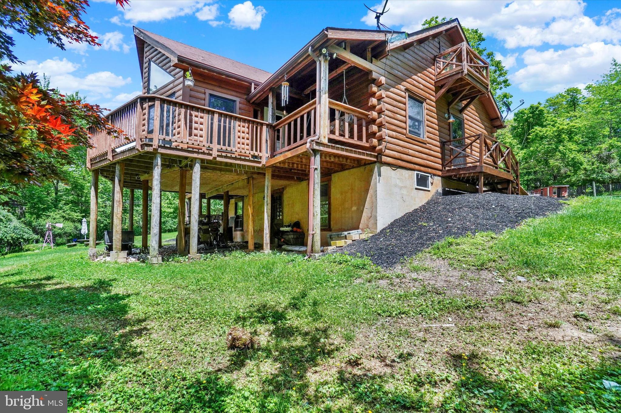News alert!!!!! Price has been reduced to $495.000 Wow what a great price
Have you ever dreamed of having the log home on the hill with your farm animals in the back yard? Do you like wildlife like deer and wild turkeys strutting through the yard? This property has all that. Sitting on almost 9 acres, so it has lots of elbow room and has a nice stream across the grass pasture area. Sellers have never used chemicals or chemical fertilizer so yes this could be an organic vegetable farm. With it being right on corner of Rt851 and Zeigler School Rds. makes it a great place for the vegetable stand to make money staying at home. This wood home has a long driveway and sits nicely back off the road, it has the wrap around deck for relaxing and enjoying the animals. As you come in the driveway you'll see a large solar panel (that is owned and will convey) so you can enjoy very very low electric bills. Open living room and kitchen concept with high ceilings with the large loft above has always been a bedroom but could be the office. There is a 4 season room with a cathedral ceiling and lots of glass making an extremely relaxing room. A small propane stove is there for the chilly nights. The lower level has a bedroom and another living area for a total of 3 bedrooms and 2 full baths and one half bath. Country living at its best but only minutes to I-83 and Stores and needed conveniences. 1 year Home Warranty included. The nice barn is 20 x 30 contains 3 horse stalls and has water and electric. Great little barn for fun animals. Goats there now and they had small horses at one time. Come live on the land.
