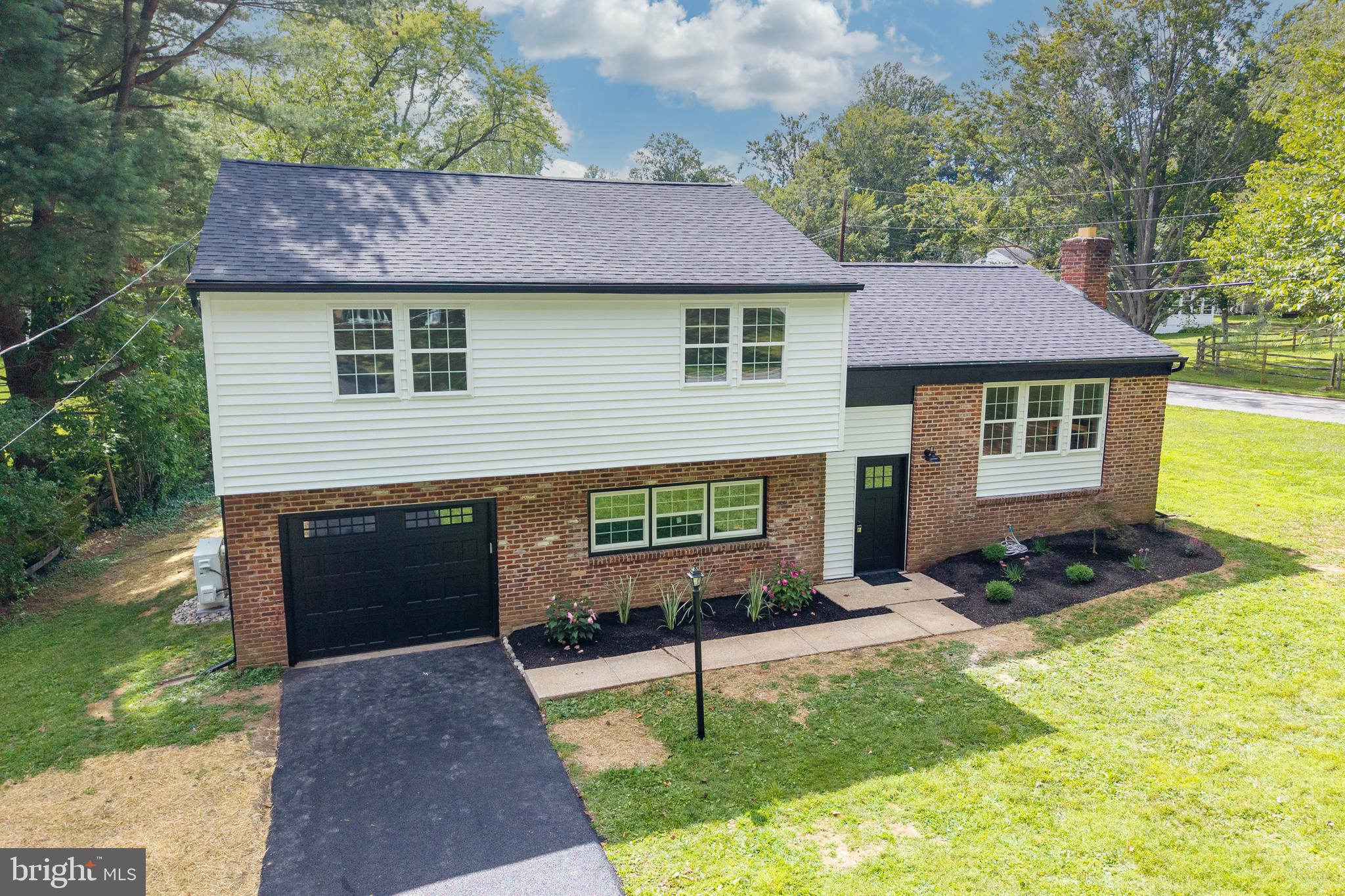Beautifully renovated 4-bedroom, 2.5-bath single home with over 1,800 square feet of living space and a 1-car garage in the highly sought-after Glen Acres community, surrounded by mature trees. This established neighborhood provides charm and character, while the home itself feels brand new thanks to extensive updates including a new roof, siding, electric, plumbing, HVAC, all new windows, kitchen, and baths.
Situated on a level 0.4-acre corner lot on a quiet street with no HOA, this bi-level home features natural hardwood flooring throughout the main level. The foyer with LVP flooring leads up a short flight of stairs to the open living area, where the spacious living room boasts a wood-burning fireplace, triple windows, and recessed lighting. The brand-new kitchen offers white cabinetry, quartz countertops, stainless steel appliances, a stylish backsplash, and a large island, opening to the dining room for easy entertaining.
The primary suite includes a walk-in shower with beautiful tilework, while three additional bedrooms and a full hall bath complete the main level. The bright, finished lower level offers natural wood-toned LVP flooring, recessed lighting, a half bath, laundry/mudroom, and access to the patio, yard, and garage.
Every detail was carefully considered in this renovation. Located within the award-winning West Chester School District and just minutes from the vibrant West Chester Borough with its shops, restaurants, and events, plus easy access to major routes, this home combines modern updates with an unbeatable location. For your peace of mind, this home has been pre-inspected.
