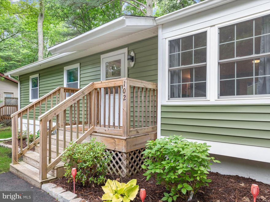 WE ARE BACK ON THE MARKET DUE TO NO FAULT OF THE SELLERS!!!

Welcome to 102 Martinique Circle, a charismatic and beautifully updated home nestled in the highly sought-after resort community of Ocean Pines. Thoughtfully maintained and recently refreshed, this residence features sleek black hardware, freshly painted interiors, and modernized kitchen and bathrooms with stylish fixtures.

Brand new carpet adds warmth and comfort throughout the home, while the kitchen and dining area feature rich laminate wood flooring, and the bathrooms are finished with durable LVP.

Crown moldings add a touch of elegance throughout, while decorative wood accent walls in the living room and hallway bring warmth and character to the interior design.
The inviting primary suite offers a walk-in closet and a modern attached bathroom with an extra-wide tiled walk-in shower, updated lighting, and contemporary black finishes. Each bedroom includes a ceiling fan for added comfort.

The backside of the stone fireplace, freshly painted white and enhanced with ceramic tile, creates a striking focal wall in the kitchen, complete with a metal hanger for pots and pans. The kitchen also features granite countertops, a built-in microwave, electric cooking, a breakfast bar, a dishwasher, and a window above the sink that frames serene views of the backyard. This inviting space has an open view to the dining area, making it perfect for both everyday living and effortless entertaining.

The living room centers around a cozy stone gas fireplace and is filled with natural light. Vaulted ceilings in the dining area enhance the sense of space, while two sliding glass doors-each exiting to newly added decks, invite the outdoors in.

Step out onto the deck and unwind in a fully fenced backyard surrounded by mature trees and bamboo, creating a peaceful and private retreat. A shed, added just two years ago, provides convenient storage for garden tools or outdoor gear. At the front of the property, you'll find a second, larger 20x12 shed—only a year and a half old—featuring a garage-style door and set on a sturdy concrete pad, offering exceptional utility and versatility.

The three-year-old washer and dryer are neatly tucked into a hall closet, offering everyday convenience without sacrificing space. The home features a six-year-old roof and recently updated siding, installed just one year ago, adding both curb appeal and peace of mind. A well-maintained driveway, completed in 2018, provides smooth and durable access to the property.

Located in a peaceful setting yet close to all the exceptional amenities Ocean Pines has to offer, this move-in ready home combines comfort, style, and community living at its finest. Residents enjoy access to a marina, pools, walking trails, sport courts, and more.