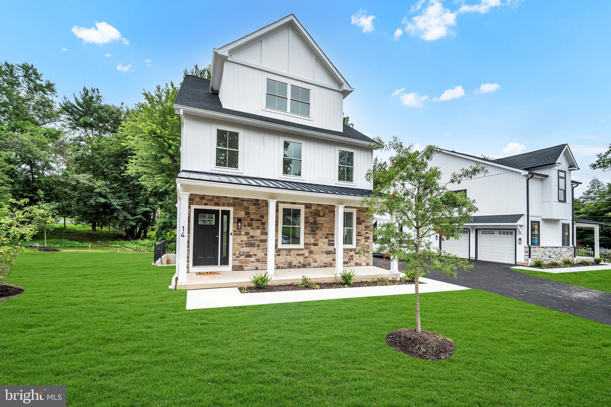 Welcome to 14 Churchville Lane, the last of only three custom-built homes in the highly anticipated Churchville Pointe community. This exquisite three-story residence features 5 bedrooms and 4.5 bathrooms, blending timeless farmhouse style architectural charm with modern luxury in a thoughtfully designed floor plan. Step inside the foyer, where wide-plank white oak flooring flows seamlessly throughout the home. The light-filled living room, anchored by a gas-burning fireplace, creates an inviting space for both everyday living and entertaining. At the heart of the home, the gourmet kitchen impresses with custom two-tone thin shaker cabinetry, striking quartz countertops, an oversized island, and high-end stainless steel appliances, including a wine refrigerator. A pantry and powder room round out the space. Upstairs, the second level hosts two bedrooms, including the luxurious primary suite—a private retreat with a massive, sun-filled walk-in closet and spa-like bath boasting large-format porcelain tile, a free-standing soaking tub, a double vanity, a private water closet, and an oversized glass shower stall. The third level offers three additional bedrooms providing flexible living arrangements for family, guests, or home office use. Outdoor living is effortless with a large, elevated Trex deck, perfect for alfresco dining or quiet moments overlooking the serene surroundings. The daylight walk-up lower level features high ceilings and an additional full bathroom—ideal for a guest suite, home gym, or media room. Perfectly situated near major transportation routes and the charming towns of Richboro, Newtown, and New Hope, 14 Churchville Lane offers the rare chance to own a one-of-a-kind, move-in ready custom home in a coveted location. Experience the pinnacle of modern farmhouse living at Churchville Pointe—schedule your private tour today.
