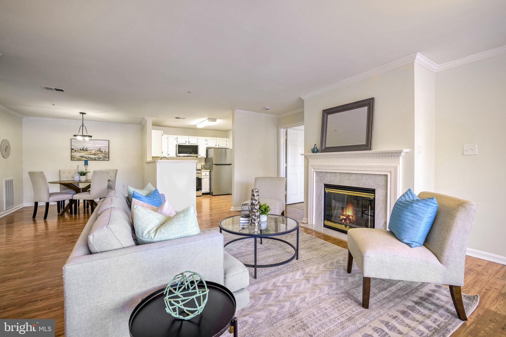 Welcome to this exquisite ground-level, 2-bedroom, 2-bathroom lakefront condo, where every room offers breathtaking lake views. Step out onto your private patio from either the en-suite bedroom or the living room, where you'll find a cozy gas fireplace with a marble surround. The kitchen is a chef's delight, featuring ample cabinetry, a breakfast bar, and brand new stainless steel appliances. A separate laundry room comes equipped with a full-size washer and dryer, along with convenient shelving. The en-suite bedroom is a true retreat, complete with a spacious walk-in closet, while both bedrooms boast new LVT flooring. You'll have one reserved parking space, plus plenty of visitor parking available. This vibrant community is ideally located near I-270 and I-355, offering easy access to everything you need. Pet lovers will appreciate the pet-friendly neighborhood, complete with green spaces, walking/jogging paths, and trails. Residents can also enjoy fantastic amenities, including an outdoor pool, tennis courts, and tot lots. Plus, this community is FHA approved, adding to its appeal. Enjoy the convenience of a ground floor, waterfront unit with stunning lake views.