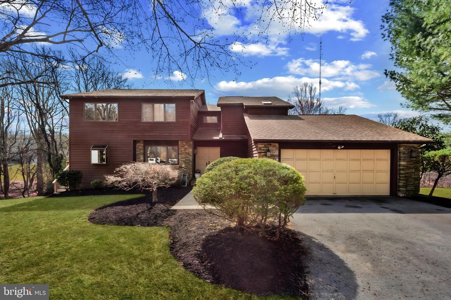 Stunning contemporary two-story home featuring 4 spacious bedrooms and 3.5 baths, all wrapped in beautiful cedar siding with a 2-car remote garage. The home is bathed in natural sunlight throughout, with two sets of sliding glass doors offering seamless access to the outdoors. Enjoy cozy evenings by the wood-burning fireplace in the inviting family room, adjacent to a custom-designed gourmet kitchen. The kitchen boasts an island, granite countertops, a 5 range gas stovetop with french doors that open to a wrap around deck. Elegant hardwood floors grace both the family and living rooms while natural stone floors enhance the dining room and kitchen. The main floor also includes a custom powder room and a convenient laundry room. Step outside to a large, wrap-around Deck, perfect for entertaining or relaxing while enjoying the serene view of the woods and stream beyond. On the second floor, the main bedroom features newly installed lVP floors, a spacious ensuite bath with a jacuzzi tub, dual sinks, and a separate shower. The second-floor loft area connects two additional bedrooms and full bath. The fully finished basement is a highlight, offering a stylish glass block bar, plush carpeting, an additional bedroom, and a full bath with a shower. You’ll also find a walk-in closet in the bedroom and ample storage space. Sliding glass doors provide access to the yard. Situated on a large lot surrounded by trees, & stream offering excellent privacy, this home is truly a Must See!  ( Owner is the Agent.)