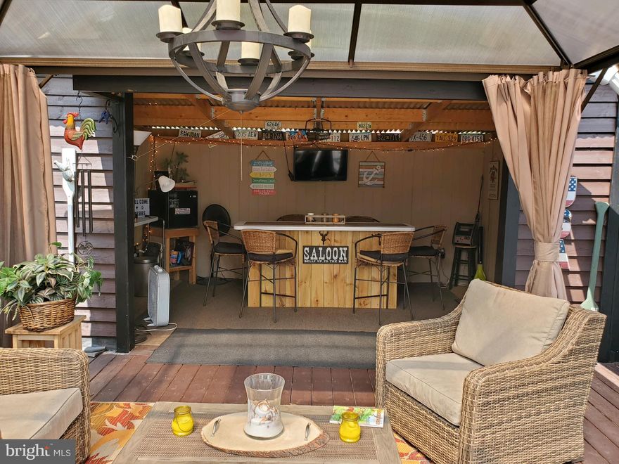 Cash Only Welcome to your newest Home away from Home. Block 5 Lot 14B Poison Oak. 
 A very nice affordable lot in Riverbend. Riverbend is 400 Acres of SEASONAL recreational camping full of amenities located on the Potomac River in Falling Waters, Wv.  OPEN APRIL 1 - NOVEMBER 1 - This is a fun community to get away and vaca or you may live here during the season. Bring your own camper, park it right at the deck and get your camping season underway! This lot has plenty of room to host your friends with 2 bar seating areas, one enclosed, one out on the deck, a gazebo (Furniture sold separately), a 3/4 of the way framed in kitchen area with sink, hot water, fridge and more! Hang up the plastic in the fall and keep your hang out space nice and toasty on those chilly evenings. 
Perfect size yard for the pets or to roast hotdogs over the campfire. The shed used to be a bathhouse and can be hooked back up. The 2021 4 seater Gator can be sold for an additional $16,000