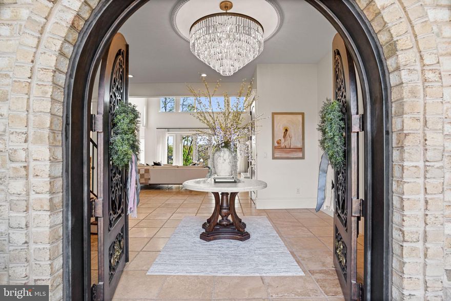 Designed for a life rooted in peace, wellness, and privacy, this refined French château-inspired estate offers a retreat that is both intentional and thoughtfully curated. Completely renovated within the past three years, the home unfolds gracefully, blending timeless architecture, natural materials, and a serene, grounded atmosphere. Hand-forged iron doors open into a bright, expansive interior where natural light takes center stage. Sunlight pours through large south-facing windows, warming the heated travertine floors and shifting gently throughout the day. Crystal chandeliers add a refined touch without overwhelming the space while antique Italian hardware and mahogany doors enhance and elevate the inviting aesthetic.

The two-story great room feels open yet balanced, with a strong connection to the outdoors. Walls of glass frame views of more than 30 acres of preserved green space, creating a sense of privacy and permanence while bringing nature into everyday living. The kitchen is thoughtfully designed for both function and gathering. High-end appliances including a Wolf range, double ovens, two dishwashers, a commercial refrigerator, and a Miele coffee station are seamlessly built into custom cabinetry. Just off the main space, a private wine cellar adds a warm and inviting element.

The primary suite is set apart, offering a peaceful, elevated perspective surrounded by trees and natural light. The en suite bath is designed for restoration, featuring a clawfoot soaking tub and a multi-head purified water shower. Upstairs, a second primary suite provides a comfortable and private space for guests, along with two additional bedrooms and a dedicated laundry area.

The lower level is centered around wellness and recovery. A marble steam room, infrared sauna, multiple showers, and a fitness studio create a space designed for both movement and relaxation. A private theater and full secondary kitchen offer flexibility for entertaining or unwinding.

Outside, a heated saltwater pool and spa blend naturally into the landscape. The expansive deck extends the living space, ideal for quiet mornings or long summer evenings.

Behind the scenes, the home is built for comfort and efficiency, with geothermal heating and cooling, a whole-home air exchanger, and integrated Control4 automation. A private elevator connects all three levels, and features including a whole-house generator and safe room provide an added layer of peace of mind. A four-car garage completes the property.

This is a home where privacy, wellness, and everyday living are thoughtfully elevated. Offering a rare opportunity, this exceptional property could include both the beautifully positioned .59-acre homesite and an adjacent .50-acre parcel—creating a combined 1.09 acre setting that enhances privacy, flexibility, and long-term value. Detailed information regarding the additional parcel is available in the associated documents or at MLS PADA2057738.