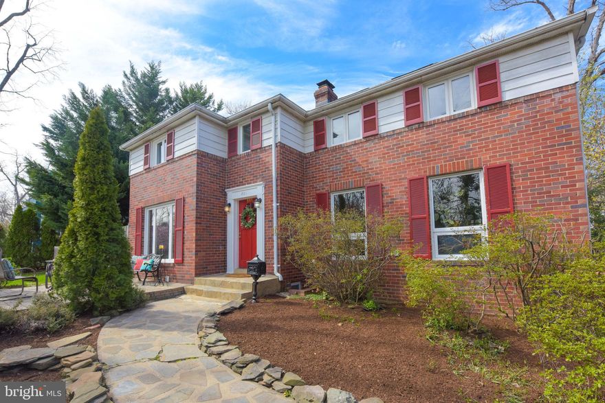 The hallmark neighborhood of Beverley Hills in Alexandria City, known for its enchanting homes, tree-lined streets, a sea of azaleas, and rolling hills, surrounds the corner lot of  801 Enderby Drive. Over one hundred trees on the ⅓ acre lot deliver a serene backdrop that will take your breath away. Enjoy yoga by the early morning golden light or during the sunset-kissed evenings on a completely secluded private lawn, thanks to the elevated parkland perched on the hill with 360-degree views. Mature Evergreens, professional landscaping, and a flagstone walkway welcome everyone into a bright setting. Two gracious levels, all above ground, provide ample natural light throughout and enhance the warmth of the rooms. Bygone era details combine seamlessly with modern delights: pristine hardwood floors, neutral fresh paint, arched doorways, crown molding, nostalgic built-in corner china cabinets, chair rail accents, and recessed lighting. The large living room is a wonderful space to entertain or relax and features a wood-burning fireplace with a mantel flanked by built-in shelves that will display collections. A perfect formal or casual dining area is conveniently located off the kitchen looking out to a private flagstone patio guarantees effortless oven-to-table meals and promises cozy family moments. Kitchens are the heart of every home and this sophisticated and recently renovated design flaunts freshly painted white cabinets, quartz countertops, ample storage, newer GE slate finish appliances (less than 2 years), glass subway tile backsplash, and a new sink faucet. A small hallway from the kitchen showcases a pantry and leads to a full bath and a great versatile room, that can be an office, sitting room, or ideal au-pair/in-law suite (5th bedroom), with a separate, private bistro patio. Connecting the living room and “sitting” room is a fantastic year-round sunroom that will become a main hangout and easily transitions gatherings inside to outside. The upper level boasts four bedrooms, a den (optional 5th bedroom) and two full baths. A dreamy primary suite flaunts a deep walk-in closet with a custom closet system, high cathedral ceilings, oversized windows, skylights, new plush carpeting, a quaint built-in bench (reading nook), and an updated ensuite bath with a dual sink vanity, new glass-walk-in shower, and calming soaking tub. An abutting room to the primary suite (the optional 5th bedroom) with French door access is another adaptable space perfect for use as an office or nursery with views of the verdant backyard. Three additional bedrooms share a charming white and black-themed bathroom. The “lower level” of this home is where you enter from the one-car garage and find the half bath and utility room. A staircase leads to the kitchen making it easy to bring groceries up directly from your car. Outdoor space is more important than ever these days and this home produces a gracious flat lot to play lawn games, shielded by noise and the street by 30 feet giant thujas, multiple stone patios for dining alfresco and staying warm by the fire pit; and cleverly designed fencing to keep four-legged friends and family safe. Driveway can park two cars. The local playground, “The Pit”, is popular along with the community’s many annual events. Residents can stroll to nearby Shirlington for dinner, enjoy happy hour at the many restaurants, or see a show at Signature Theater. The shops and restaurants of Del Ray, the Fairlington Shopping Center, and the Bradlee Centre are also an easy walk. Old Town, the Pentagon, and Crystal City (Amazon HQ2) are all just five minutes away by car. City workers will love the feel of living in a forest and yet minutes away from access to I-395 as well as Metro and bus services; dedicated shuttle to The Pentagon stations metro or bus. Many neighbors, who work in DC, use the Dash AT4 bus and enjoy a 30-minute door-to-door commute. Lots of love was put into this home to make it sparkle.