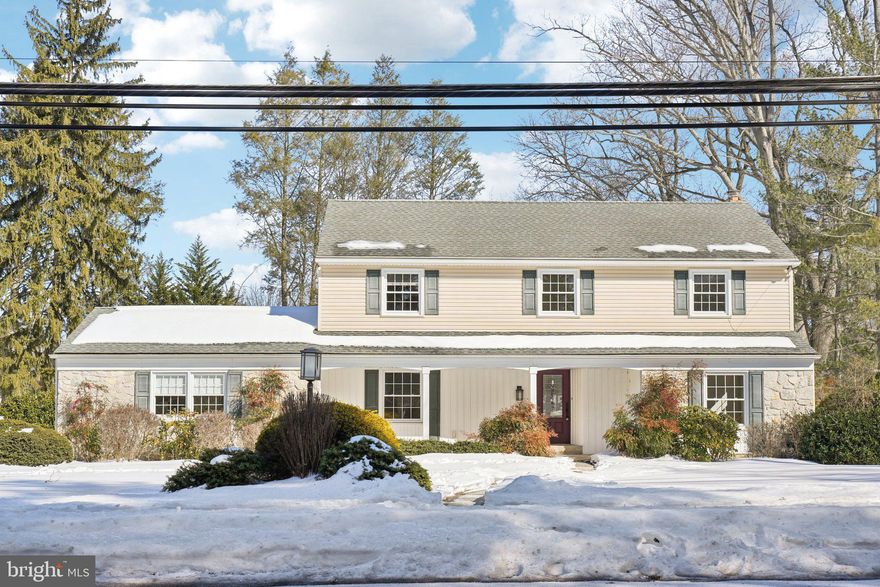 241 Moreland Road presents a well-maintained colonial in Huntingdon Valley, offering 4 bedrooms, 2.5 baths, and 2,254 square feet of living space on a nearly half-acre lot. A classic layout, thoughtful updates, and exceptional outdoor areas create an easy setting for daily living and entertaining. A covered front porch adds charm and offers a welcoming place to relax before stepping inside to a traditional floor plan that feels both inviting and functional. The bright corner living room features two large windows, while the dining room showcases custom doors, a hallway china cabinet, chair rail detail, and an oversized front window for added sunlight. The custom eat-in kitchen includes rich dark wood cabinetry, high-end appliances, a newer Fisher & Paykel refrigerator, gas cooktop with copper hood and a bay window overlooking the flagstone patio, ideal for everyday meals and casual gathering. Just off the kitchen, the spacious family room features a bay window seat with cushion, beamed ceiling and a brick gas fireplace with mantel. Flanked by custom wood bookcases, the fireplace creates an eye-catching focal point and a comfortable place to unwind. A convenient service corridor includes the laundry area, powder room, mudroom with access to the driveway and the attached two-car garage. Upstairs are four bedrooms with ample closet space, including a large primary suite with multiple closets and an updated en-suite bath. The updated hall bathroom includes a tub, and a hallway cedar closet provides additional storage. Outdoor living shines with a three-season room featuring a slate floor, a flagstone patio, and a well-kept yard ideal for dining, relaxing, or enjoying time outdoors. The unfinished basement provides abundant storage and excellent potential for future finished space—such as a gym, recreation area, or flex room. The garage is equipped with a Tesla charger for at-home charging convenience, added storage cabinets and the home offers 200-amp electrical service.  Home includes gas baseboard heating and central hair conditioning.  Located in the Lower Moreland School District and walking distance to the train station, with nearby access to the Pennypack Trail, shopping, and convenient routes to I-95, this home offers space, comfort, and a setting to enjoy year-round.