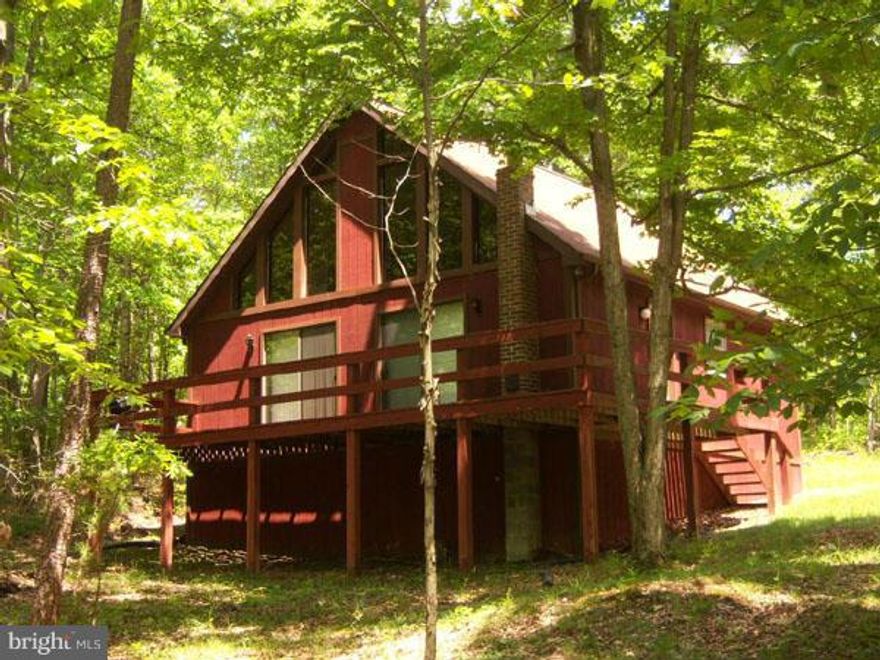 Chalet in the woods, open floor plan with huge window wall taking in all of natures beauty on 2.26 acres. One bedroom and loft that can easily sleep six, washer and dryer hook up, large deck. All freshly painted, stained with furnishings and ready to enjoy. Nice roads and close to Cacapon State Park and Sleepy Creek Wildlife Management Area for all your outdoor activities. Give us a call!