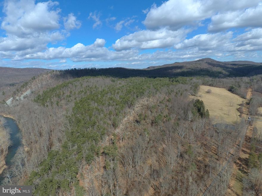 CACAPON RIVER COMPOUND....153 UNRESTRICTED ACRES THAT CHECKS EVERY BOX: 275 FT OF FRONTAGE ON THE CACAPON RIVER FOR FISHING, SWIMMING, CANOE & KAYAK. 13 ACRES OF PASTURE FOR LIVESTOCK & GARDENS AND STOCKED POND. THE LAND LAYS GREAT, VERY GENTLE TOPO AND MILES OF ESTABLISHED ATV TRAILS. ABSOLUTELY LOADED WITH GAME FOR THE HUNTER, STANDS ALREADY IN PLACE....BIG BUCKS, BEAR & GOBBLERS LIVE HERE! THE HOME HAS BEEN RECENTLY UPGRADED WITH UPDATED BATHROOMS, LAMINATE & HARDWOOD FLOORING, REPLACEMENT WINDOWS, ETC.  LOTS OF GLASS = LOTS OF NATURAL LIGHT AND ALLOWS YOU TO SOAK IN THE AMAZING VIEWS FROM JUST ABOUT EVERY ROOM. RETRO & MODERN STYLING COLLIDE INSIDE TO PRODUCE A CHIC LIVING SPACE. LOCATED NEAR THE DEAD END OF A COUNTY MAINTAINED ROAD, YOU'LL ENJOY ALL THE PRIVACY, PEACE & QUIET YOU DESERVE. IT FEELS LIKE YOU'RE IN THE MIDDLE OF DOWNTOWN NOWHERESVILLE BUT YOU'RE LESS THAN 30 MINUTES FROM WINCHESTER, VA AND ONLY 96 MILES FROM THE WHITE HOUSE. STAY CONNECTED WHILE YOU DISCONNECT WITH GREAT CELL SERVICE, STARLINK SATELLITE INTERNET AND WHOLE HOUSE GENERATOR. BOXES CHECKED: VIEWS, WATER, FIELDS, WOODS, PRIVACY & CONNECTIVITY. HUNT, SHOOT, FISH, ATV'S......WITHOUT EVER LEAVING YOUR PROPERTY!  THE ULTIMATE RECREATIONAL RETREAT OR YOUR FULL TIME ESCAPE FROM CIVILIZATION.....PROPERTIES LIKE THIS ARE ON THE ENDANGERED SPECIES LIST.....SEIZE THIS OPPORTUNITY TO OBTAIN A TRUE LEGACY PROPERTY FOR GENERATIONS TO ENJOY!