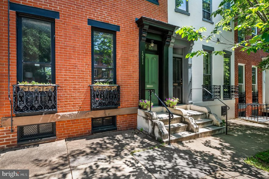 Beautiful end-of-group townhouse in the heart of historic Bolton Hill, offering timeless architectural character, abundant natural light, and a thoughtfully reimagined floor plan designed for modern living. Rich with historic charm, the home showcases original architectural details, including interior shutters, hardwood floors, built-in shelving, and an elegant fireplace mantel that reflects the craftsmanship and character of the period.

On the main level, the original kitchen and dining room have been combined to create a more contemporary and open living space ideal for both everyday living and entertaining. The reconfigured layout offers excellent flow and functionality while maintaining the warmth and charm of the original home. The kitchen and dining area open directly onto a charming courtyard garden — a private urban retreat perfect for morning coffee, container gardening, or intimate outdoor entertaining. The end-of-group location provides additional windows and wonderful natural light throughout the home.

Upstairs, the original four-bedroom layout has been thoughtfully reimagined to create two spacious bedroom suites, a third smaller bedroom, and a flexible den or office space ideal for today’s lifestyles. Additional features include radiator heat, two-zone central air conditioning, a lower-level laundry area with excellent storage and workshop space, and off-street parking for one car along the side of the home. 

Conveniently located near neighborhood parks, cultural institutions, local restaurants, Penn Station, and major commuter routes, this home offers the perfect blend of historic elegance and modern city living in one of Baltimore’s most beloved neighborhoods.