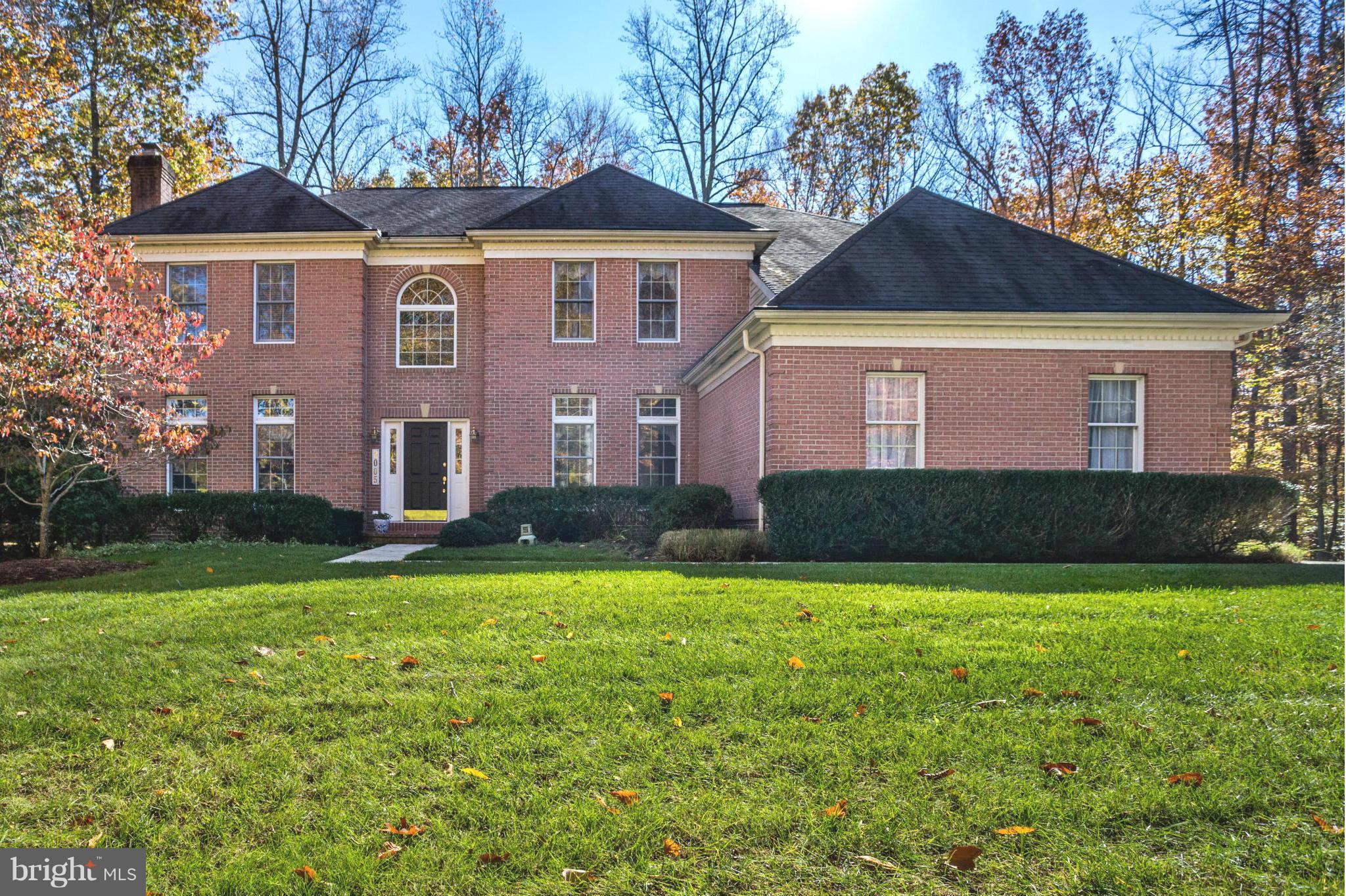 Shimmering with sunlight, step inside this elegant, Federal-style home featuring spacious, angled rooms, a marbled entry, and gleaming wood floors on the first level! A dramatic wall of windows and soaring ceilings, allows family room to offer spectacular views of the lush backyard! All-white kitchen. Lower, walk-out level is ready to be finished w/9' ceilings! Full-house generator!