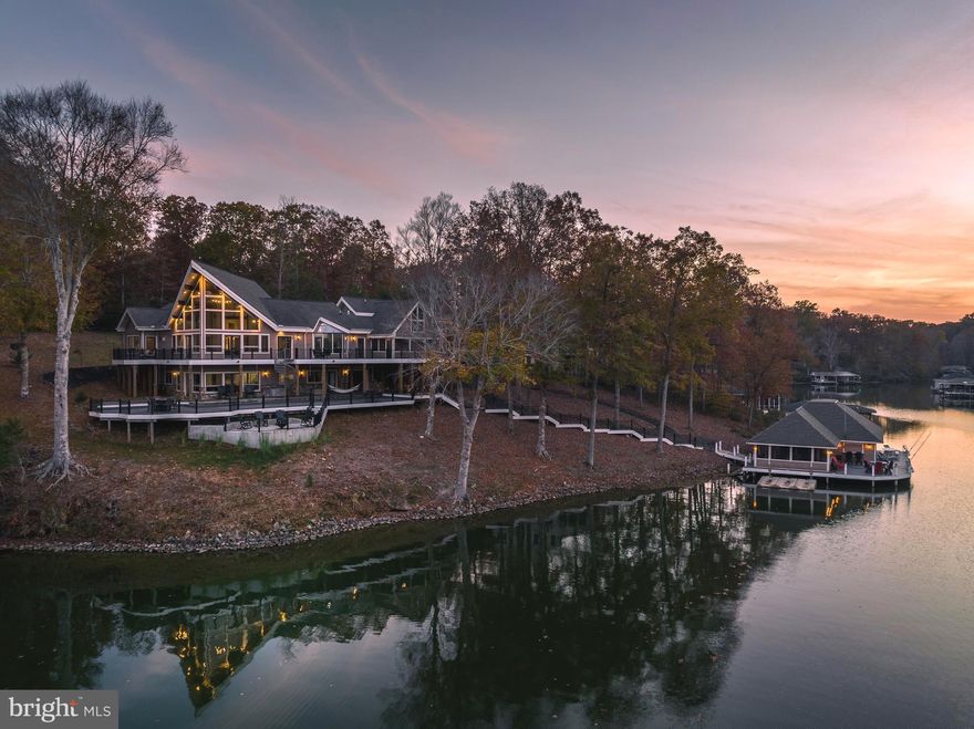 For those seeking waterfront living at its finest, we offer a private paradise on Lake Anna.  A stunning waterfront masterpiece with soaring vaulted ceilings, this custom oasis on the public side of Lake Anna offers spectacular water views and calming privacy.  Truly unrivaled in quality and design, this impeccably crafted escape blends modern luxury living with tranquil lake lifestyle.  Encompassing over 5,000+ square feet on two open levels, this paradise offers seamless indoor/outdoor lakeside living, with 4 spacious bedrooms, 2 full baths, 2 half baths and a finished studio apartment above the garage complete with a kitchen, full bath, laundry and additional room for sleeping.  Tremendous multi-level back deck living area (upper and lower levels) constructed of composite decking overlooking the water with  250+ feet of private shoreline protected by riprap.  Main level showcases a massive open great room with soaring atrium windows, cathedral ceilings finished with wood and exposed beams, sunny open floor plan, and a stone raised hearth fireplace.  Here, you enjoy gorgeous water views from most all rooms in the house!  The bright breakfast room is surrounded by a glass atrium and is open to the dining area and gourmet kitchen that supplies stainless appliances, multiple islands with suede granite countertops and oversized glass pendant lights that levitate weightlessly above the breakfast bar.  The primary bedroom suite is located on the main level, with its own private access to the large deck overlooking the lake (there is extra reinforcement on this portion of the deck to support a hot tub) and en suite primary bathroom with a jetted tub, double vanity & separate tile shower and water closet.  Downstairs in the expansive walkout basement, you’ll enjoy the same jaw-dropping water views, a family room, full kitchen and 3 more bedrooms.  This lake escape is located on a deep water, no-wake cove overlooking the main lake.  A few steps away at the water, you’ll enjoy warm summer days down at on your private deep water boathouse with composite decking (18+ feet water depth at boathouse), 2 boat slips with electric lifts, double jet ski pad, tiki bar, sun deck, large screened porch and a storage room.  Paved driveway, oversized 3 car garage and there is also a paved golf cart path to the boathouse for added convenience.  This lake escape is located on a quite cul-de-sac for ultimate privacy with high speed fiber internet.  Talk about a great central lake location; this oasis is less than a  2-minute drive from groceries, dining, ABC store, breweries and cideries.  Fox Business recently named Lake Anna THE TOP “beach” vacation investment location in the entire nation - this lakefront paradise would make an incredibly lucrative investment asset and it COMES FURNISHED!  Many improvements have also been made to this property (see list of exclusions and improvements in MLS documents section).  Lake Anna will forever serenade your senses at this exclusive waterfront paradise.  Come see for yourself and fall in love!