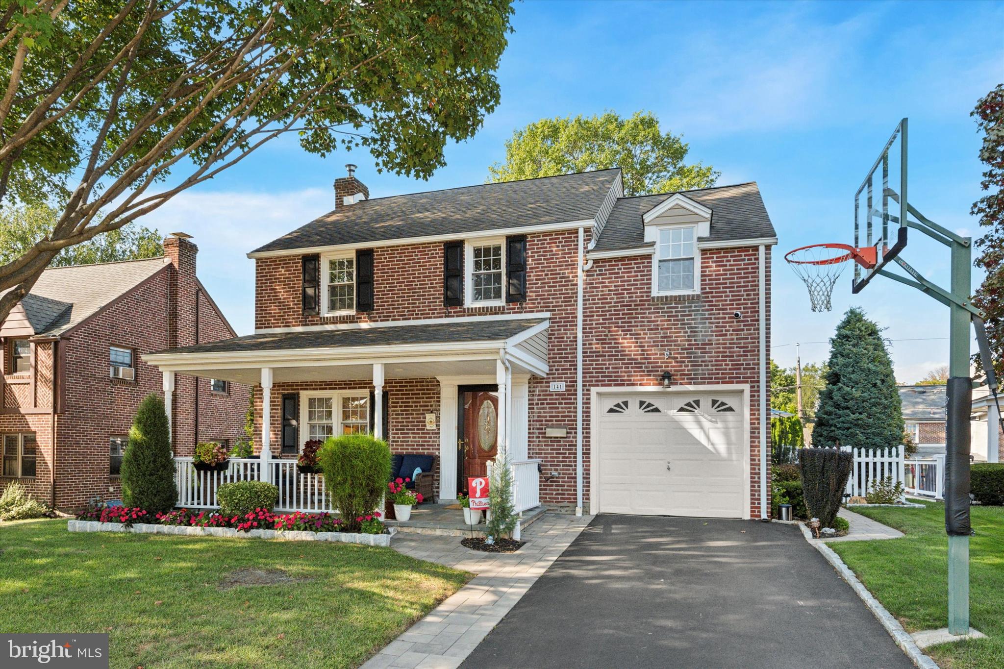 Welcome to 141 Friendship Road in the HAVERFORD TOWNSHIP section of Drexel Hill! Wow! This brick colonial home is incredibly maintained and beautifully updated, inside and out. It’s rare to find a home this complete! Walking up you’ll notice the lush lawn, welcoming covered front porch and private driveway leading up to the storage garage (reduced in size to expand the kitchen). Stepping into the home, beautiful hardwoods not only run throughout the first floor but run seamlessly into the family room addition, connecting the entire space. The first floor starts with a good sized living room with built in book shelves. Next the formal dining room opens to a stunning renovated kitchen with breakfast bar, quartz countertops, tile backsplash, stainless appliances including an induction stove, loads of cabinetry, recessed lighting and a great window over the sink, looking to the back yard. Two openings, one from the kitchen and one from the dining room, lead into the family room that presents great entertaining space with a vaulted ceiling, as well as, beautiful windows and a large slider that leads out to an amazing outdoor space. Out side you’ll find a newer dark gray composite deck with white vinyl rails, a built in hot tub, plenty of room for entertaining and a great view of the fenced rear yard. If you enjoy hanging outside, the yard, front covered porch and rear deck spaces are hard to beat. The second floor presents 3 great sized bedrooms with good closet space, as well as a renovated hall bath with new double sink vanity, tub, tile floor and surround. The 3rd bedroom includes an extra bump out, big enough for bed and dresser or a great space for a 2nd floor office. Additionally, the second bedroom includes pull down attic access, providing convenient storage with a floored attic space. Stairs off the kitchen lead down to a finished basement with vinyl plank flooring, a nicely renovated half bath, a storage/utility room and a laundry room with washer and dryer. Other great features of the home include the storage garage out front, 200 Amp electric, insulated windows. Located on a sidewalk neighborhood street, you are minutes from parks (Merry Place, Steel Field), trails along Darby Creek, shopping and restaurants along Township Line & W. Chester Pike, and local schools (Haverford Public Schools - Manoa Elementary). Don’t miss this wonderful move in ready opportunity!