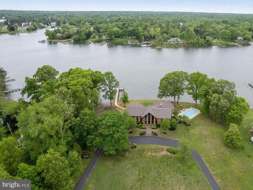 PRICE IMPROVED! THE SUMMER SPOT. This very protected waterfront property has an incredible lot with an easy walk to the pier, a private boat ramp area and incredible outdoor living spaces on the creek. Solid brick  5000SF+ contemporary home,  inground pool and private pier on 2.3 acres.  The  creek views are captivating.  Dramatic foyer, two levels of incredible interior spaces that flow onto two levels of outdoor living. Vaulted ceilings, big windows, updated interior features such as wet bar with dual beverage fridges, an under-counter nugget ice maker. The outdoor living is large and fantastic, focused on the pool and the pier. The  290' of shoreline on Cuckold Creek is rip-rapped, and the private pier was just rebuilt...with an opportunity to add more features. See pier permit drawings in MLS documents. The location offers DEEP WATER FOR YACHTING, quick access to the Patuxent River and Chesapeake Bay for cruising, fishing, water sports and heading to your favorite restaurant. Beautiful Half Pone Point is a very desirable waterfront peninsula between the Patuxent River and Cuckold Creek, and this is without question one of the finest properties on the point. There are two smaller outbuildings on the property(21 x 17 + 11 x 11) , awaiting the next owner's use and perhaps some outdoor living imagination. Cabana at the water's edge? Studio or shop building? MOVE IN READY and geared toward your enjoyment this summer. Don't miss an opportunity to live on Half Pone Point!