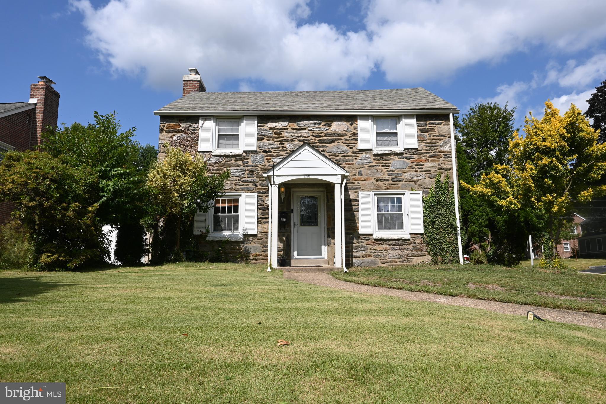 Beautiful Stone Colonial sits on Deep Corner Lot on Quiet Street in Desirable Springfield. Whether by Foot or Car this Location is very Convenient and close to Everything - Walk to Schools, Parks, Library, Shops and Public Transportation! Enjoy Large Spacious Living Room with Center Fireplace, warm Hardwood Floors and Deep Sunny Window Sills. This Home offers Formal Dining Room (which is Currently used as casual sitting Room) with Chair-rail and Hardwood Floors. The Kitchen is Updated with Granite Countertops, Backsplash, Dishwasher, Stainless Steel Fridge and Gas Cooking and Offers Outside Exit to Private Driveway and Fully Fenced, two tier Level Backyard. Enjoy Privacy inside the Enclosed Patio, Great for BBQ's, Cool Fall Nights or any Outside Recreation and Entertaining! Back Inside, the Large Family Room with Vaulted Ceiling and Deep Bay Window rounds out the Main Floor. Upstairs finds the Large Master Bedroom with Walk-In Closet, En Suite Powder Room and Hardwood Floor. The Ceramic Tile Hall Bath and Two Additional Nicely Sized Bedrooms (One of which has an Extra Long Walk-In Closet!) complete the Second Floor. Downstairs the Finished Basement offers Extra Living Space with it's own Outside Exit Accessed off the Driveway. The Basement has a Separate Adjoining Room which can be set up easily for Home Office. The Laundry/Utility Room is also Separate and offers Extra Storage and work space as well.