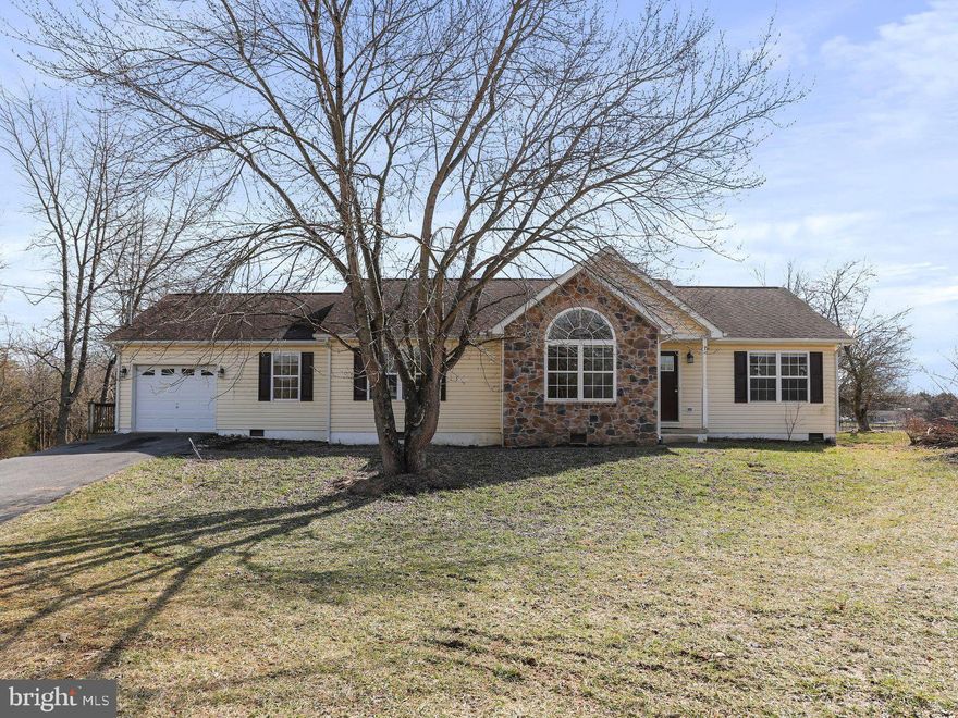 Indulge in the tranquility of this picturesque ranch-style residence situated on more than 5 acres! Featuring a roomy Great Room boasting a striking stone fireplace, a modernized kitchen complete with granite countertops, a generous pantry, stainless steel appliances, and an inviting dining area. The cozy Family Room provides ample space for hosting gatherings. New flooring throughout,  multiple decks, and ample storage in your oversized 1-car garage. The serene atmosphere is enhanced by a gently babbling creek that meanders through the property. Kindly note, the bridge over the creek is purely for visual purposes and is not intended for pedestrian use.