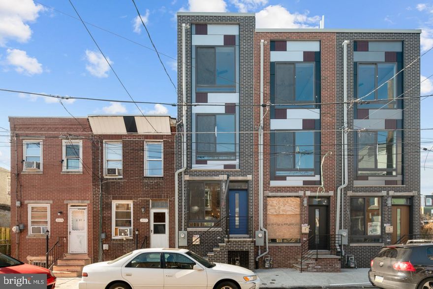 Last available of three! Welcome to this beautiful NEW CONSTRUCTION townhome located in the family-oriented, community-driven Port Richmond neighborhood with 10-year tax abatement. The spacious living room welcomes you with wide plank oak hardwood floors flowing into the kitchen complete with modern granite countertops, white shaker soft cabinets, stainless steel appliances, and entry to a private, fenced-in rear yard. Walk up the stairs to 2 big bedrooms with generous closet space, large windows, designer bathroom, and 2nd-floor washer dryer. Continue upstairs to the Master  Suite with a private wet bar, trey ceiling and a gorgeous Master Bathroom featuring a dual vanity and glass shower. Walk up to the roof deck to entertain and appreciate the breathtaking Philadelphia skyline. This home features a pre-wired speakers, security system and a 1-year Builders Warranty. Great value in this hot up and coming neighborhood for only 300k. Your new home is located in the perfect area for shopping and dining at some incredible Philly staples, including Tacconelli's Pizza and Hinge Cafe. Very accessible to I95, and multiple public transportation options.