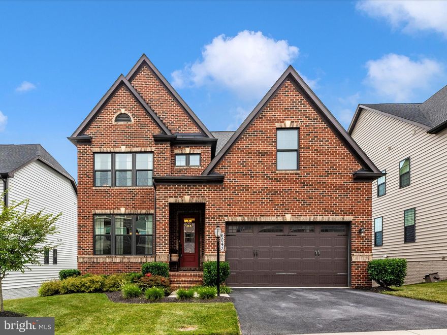 This Colonial brick front beauty being offered in the highly demanded Lake Linganore at Oakdale neighborhood, is without a doubt, a show stopper. Just 5 years young, this stately home has been meticulously maintained by the owners, keeping it clean and manicured for you to enjoy and make your own. Inside is wide open with plenty of storage space, closet space,  and a private office area for a work from home position. The grand eat in kitchen with top tier stainless steel appliances, gorgeous quartz counter tops and oversized island with seating for all,  opens right up to the living space. Sitting just off the kitchen is a beautiful covered deck with unobstructed views of woodlands and nature paths, allowing the perfect setting for either entertaining or relaxation. The upper level hosts the owners suite detailed with tray ceiling and a view of nature, has dual walk in closets and a bathroom that is made for relaxing at it's finest. As well as the other bedrooms, with access to private bathroom as well as shared bathroom. In the basement you'll find plenty of extra indoor storage, and plenty of open space,  plus a full bar to continue the entertaining inside or to kick back and relax in your own pub at home.  The area is booming and growing. Keeping you in close proximity to schools, restaurants, bars, grocery stores, professional offices and more. Convenient access to major commuter routes and all the amenities that Lake Linganore has to offer including pool, lake with beach and boating, and nature trails.