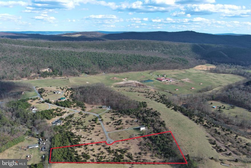 PRIVATE PREMIUM BUILDING LOT....6.28 GORGEOUS ACRES OF CEDARS & GRASSLANDS WITH ELEVATED BUILD SITE, OFFERING GREAT VIEWS OF NORTH RIVER MOUNTAIN AND ADJACENT FARM. TUCKED AWAY AT THE END OF ROAD AND BUILD SITE IS SHROUDED BY EVERGREENS FOR YEAR ROUND PRIVACY. OVERLOOK THE ENTIRETY OF YOUR LAND FROM THE HOME SITE. POWER & PERKED, FIBER INTERNET IN THE COMMUNITY. A UNIQUE PROPERTY THAT COMBINES THE FEELINGS OF THE MONTANA FOOTHILLS AND WEST VIRGINIA MOUNTAINS. EASY TO GET TO BUT HARD TO FIND, ONLY 2.5 MILES OFF RT 50, 35 MINUTES FROM WINCHESTER, VA AND 2 HOURS WEST OF THE WHITE HOUSE! NEWER COMMUNITY WITH NICE HOMES, RESTRICTED TO PRESERVE THE PRISTINE SETTING AND QUIET ENVIRONMENT. NO HUNTING, SHOOTING, ATV'S OR LIVESTOCK. THIS LOT IS MEANT FOR BUILDING, NOT RECREATION. IT'S TIME TO ESCAPE THE HUSTLE, BUSTLE, NOISE & TRAFFIC OF SUBURBIA....IT'S TIME TO HEAD TO ALMOST HEAVEN!