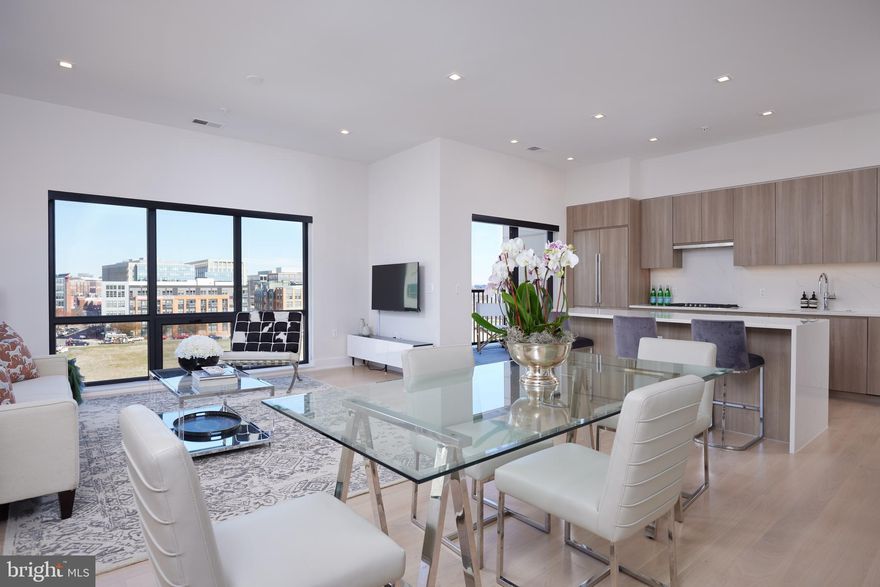 Live luxuriously and at a LOWER INTEREST RATE! Sellers are offering a closing credit towards buyer interest rate buydown with an accepted offer! * 

PENTHOUSE living at its finest: this nearly new, meticulous and move-in-ready top floor two bedroom + den (or third bedroom), two full, and one half bath condominium is ready for its lucky new owners. 

Relax and enjoy or entertain in style as the terrific floor plan boasts a dramatic entry foyer and gallery hall, luxuriously-scaled living and dining areas smartly situated around a chic and sleekly appointed kitchen with full custom cabinetry, polished quartz counters, and a sensationally-scaled center island. These dramatic rooms are all punctuated with floor to ceiling windows, soaring ceilings, and fantastic views of the Potomac River, the Capitol dome, and airplanes taking off and landing at National Airport. The sense of volume, light, and air is simply magical throughout and is further enhanced by a private outdoor space accessed directly off of the kitchen.

The incredible primary suite delivers in droves, too. Grand enough to easily accommodate a king-sized bed and furnishings, yet intimate and serene in feel, this quiet oasis offers a fabulous en-suite bathroom plus divine, dual walk-in closets each outfitted by the acclaimed firm, Capitol Closets. Perfectly positioned, the second bedroom is bright and spacious and is wonderfully appointed with its own en-suite bathroom and terrific walk-in closet. A discreet powder room is located just off of the foyer while the sizable and flexible den/third bedroom sits quietly off the main living area.

The Dylan is a refined and elegant address and boasts a lovely array of amenities that include secure entry, concierge, parking garage (2 private spaces convey with the sale of #604), extra storage (1 private locker coveys with the sale of #604), business center, art/project room, fantastic party room, and large common outdoor terrace with grill and lounging areas. The location is absolutely stellar with ease of access to DC, Old Town and beyond, Potomac Yards/VT Metro stop (Blue and Yellow lines and an approximate 7 minute walk from the building), green spaces galore, plentiful restaurants and shopping choices. A rarely available penthouse in absolutely top condition and in a top location. Sounds like the perfect time to move on up!

*