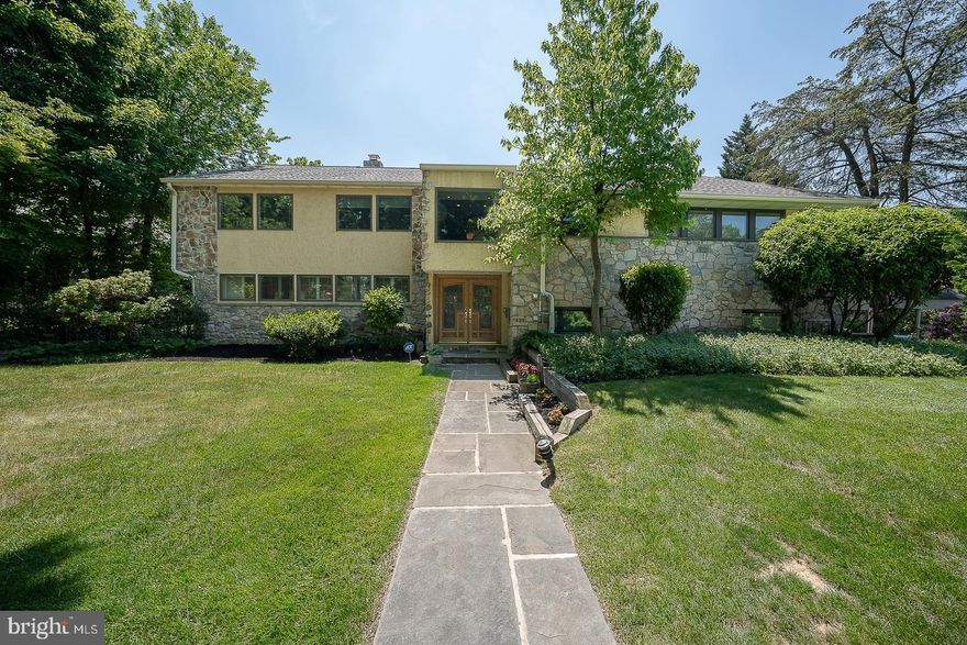 A custom designed and welcoming  4-6 bedroom Wynnewood home that “checks all the boxes” offering a
casual, yet sophisticated lifestyle. Located in one of Lower Merion’s most sought after
neighborhoods, 1436 Hillside Rd. sits on a beautiful tree lined street in the heart of the
Main Line.
From the moment you enter the leaded glass double door it’s apparent you are in
a special place. The vaulted stone walled Foyer has an open view to the upper level landing
accented with a brass and metal custom railing. The main level has a spacious Living
Room with a brick wall, wood floors and corner fireplace opening to a grand Dining Room,
with French doors to the rear patio. The expanded remodeled Kitchen is a chef’s delight.  A
large quartzite island, beverage center and mini office create a lively central hub with
plenty of space to entertain. Completing the Kitchen area is a spacious airy breakfast room
with Plantation shutters and vaulted ceilings, overlooking the beautifully manicured
backyard. The fully fenced rear flat grounds feature a stamped concrete patio, lovely
heated pool, built-in gas grill and a storage shed.
The walk out Lower Level of the home serves as a Recreation/Family Room. It has
porcelain tiled floors, a remodeled Powder Room, full stone wall with fireplace and slate sills,
and a wall of windows with views of rear yard. The Laundry Room has built in storage
cabinets, a utility sink and second refrigerator. There is an entrance to the attached
Garage, which leads out to a 3 car carport.
The third level has four Bedrooms which includes the primary Bedroom suite, equipped
with a fully outfitted walk-in closet, a remodeled ensuite Bathroom with two sink vanities,
shower, quartz counter tops and a tiled floor. The three additional bedrooms are well
proportioned. The tiled hall Bathroom features a double sink and a tub/shower.
The top level has two additional Bedrooms, one with a vaulted ceiling and skylight,
currently being used as a home office. An attractive tiled hall Bathroom has a Jacuzzi tub
with a skylight above the tub area. Completing this level is a second Recreation/Family
Roon with dramatic vaulted ceilings, two Casablanca “Stealth” fans, two skylights, and
storage closets. You will never want to leave this room, it’s so comfortable, and relaxing!
This level is wired for surround sound in all the rooms. There is also an entrance from the
landing to a good sized floored Attic which includes a cedar closet, excellent for storage.
This home truly has it all; beautiful wood floors ,  recessed
lighting, Plantation shutters in many rooms, 6 zoned heat  and 3 zone central air, windows galore.  Impeccably maintained and updated throughout.  An easy
flow and spacious rooms offer the ability to live graciously with style and comfort. Award
winning Lower Merion Schools, minutes to R-5 train, shopping, Whole Foods, Suburban
Square, Trader Joes, plus fine dining, minutes to Center City and Western Suburbs. Many furnishings may be available for purchase.
