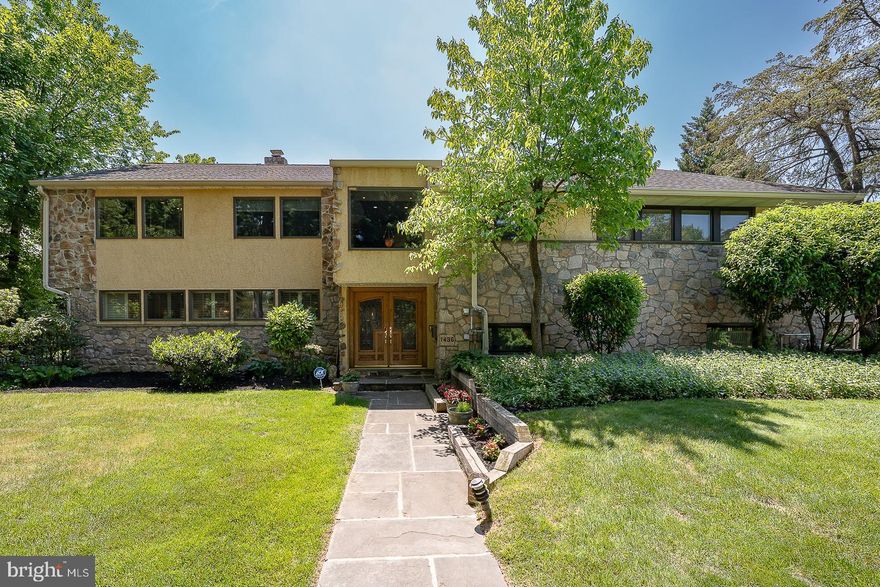 A custom-designed and welcoming 4-6 bedroom Wynnewood residence that truly “checks all the
boxes,” offering a sophisticated yet comfortable lifestyle in one of Lower Merion’s most sought-
after neighborhoods. Perfectly situated on a beautiful tree-lined street in the heart of the Main
Line, 1436 Hillside Road combines timeless character, generous living spaces, and exceptional
amenities for today’s lifestyle.
From the moment you enter the leaded glass double doors, it is immediately apparent you are
entering a very special home. The dramatic vaulted stone-walled foyer opens to the upper-level
landing highlighted by an elegant custom brass and metal railing, creating a striking architectural
focal point.
The main level offers an ideal blend of gracious entertaining spaces and comfortable everyday
living. The spacious Living Room features rich wood flooring, a stunning brick accent wall, and
a corner fireplace, flowing seamlessly into the grand Dining Room with French doors leading to
the rear patio and backyard oasis.
The expanded and beautifully remodeled Kitchen is truly the heart of the home and a chef’s
dream, featuring a large quartzite island, beverage center, mini office area, abundant cabinetry,
and exceptional workspace. Adjoining the Kitchen is a sun-filled Breakfast Room with vaulted
ceilings and Plantation shutters overlooking the beautifully landscaped grounds.
Designed for both entertaining and relaxation, the fully fenced rear grounds offer a resort-like
setting complete with a stamped concrete patio, heated swimming pool, built-in gas grill, and
storage shed.
The walk-out Lower Level serves as an exceptional Recreation and Family Room featuring
porcelain tile flooring, a remodeled Powder Room, dramatic full stone wall with fireplace and
slate sills, plus a wall of windows overlooking the rear yard. The Laundry Room includes built-
in cabinetry, utility sink, and second refrigerator. Access to the attached Garage leads directly to
the expansive three-car carport.
The third level offers four Bedrooms, including the luxurious Primary Suite with professionally
outfitted walk-in closet and renovated ensuite Bath featuring double vanities, quartz countertops,
oversized shower, and tiled flooring. Three additional Bedrooms are spacious and well
proportioned. The tiled hall Bathroom includes a double sink vanity and tub/shower
combination.
The top level provides incredible flexibility with two additional Bedrooms, one currently used as
a home office featuring vaulted ceilings and skylight. A beautifully tiled hall Bath includes a
Jacuzzi tub positioned beneath a skylight. Completing this level is a second Recreation/Family
Room with dramatic vaulted ceilings, two Casablanca “Stealth” ceiling fans, dual skylights,
storage closets, and surround sound wiring throughout the entire level. This inviting space is the
perfect retreat for relaxing, entertaining, or enjoying movie nights.
Additional features include a large floored attic with cedar closet, beautiful wood flooring,
recessed lighting, Plantation shutters, abundant windows providing natural light throughout, six-
zone heating, and three-zone central air.
Impeccably maintained and thoughtfully updated throughout, this exceptional home offers an
easy flowing floor plan, spacious rooms, and the perfect balance of elegance, warmth, and
comfort.
Ideally located within award-winning Lower Merion Schools and just minutes to the R-5 train,
Suburban Square, Whole Foods, Trader Joe’s, fine dining, Center City Philadelphia, and the
Western Suburbs.
Many furnishings may be available for purchase.