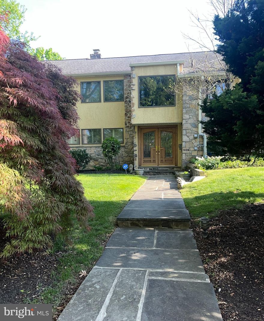 A custom designed and welcoming  4-6 bedroom Wynnewood home that “checks all the boxes” offering a
casual, yet sophisticated lifestyle. Located in one of Lower Merion’s most sought after
neighborhoods, 1436 Hillside Rd. sits on a beautiful tree lined street in the heart of the
Main Line.
From the moment you enter the leaded glass double door it’s apparent you are in
a special place. The vaulted stone walled Foyer has an open view to the upper level landing
accented with a brass and metal custom railing. The main level has a spacious Living
Room with a brick wall, wood floors and corner fireplace opening to a grand Dining Room,
with French doors to the rear patio. The expanded remodeled Kitchen is a chef’s delight.  A
large quartzite island, beverage center and mini office create a lively central hub with
plenty of space to entertain. Completing the Kitchen area is a spacious airy breakfast room
with Plantation shutters and vaulted ceilings, overlooking the beautifully manicured
backyard. The fully fenced rear flat grounds feature a stamped concrete patio, lovely
heated pool, built-in gas grill and a storage shed.
The walk out Lower Level of the home serves as a Recreation/Family Room. It has
porcelain tiled floors, a remodeled Powder Room, full stone wall with fireplace and slate sills,
and a wall of windows with views of rear yard. The Laundry Room has built in storage
cabinets, a utility sink and second refrigerator. There is an entrance to the attached
Garage, which leads out to a 3 car carport.
The third level has four Bedrooms which includes the primary Bedroom suite, equipped
with a fully outfitted walk-in closet, a remodeled ensuite Bathroom with two sink vanities,
shower, quartz counter tops and a tiled floor. The three additional bedrooms are well
proportioned. The tiled hall Bathroom features a double sink and a tub/shower.
The top level has two additional Bedrooms, one with a vaulted ceiling and skylight,
currently being used as a home office. An attractive tiled hall Bathroom has a Jacuzzi tub
with a skylight above the tub area. Completing this level is a second Recreation/Family
Roon with dramatic vaulted ceilings, two Casablanca “Stealth” fans, two skylights, and
storage closets. You will never want to leave this room, it’s so comfortable, and relaxing!
This level is wired for surround sound in all the rooms. There is also an entrance from the
landing to a good sized floored Attic which includes a cedar closet, excellent for storage.
This home truly has it all; beautiful wood floors ,  recessed
lighting, Plantation shutters in many rooms, 6 zoned heat  and 3 zone central air, windows galore.  Impeccably maintained and updated throughout.  An easy
flow and spacious rooms offer the ability to live graciously with style and comfort. Award
winning Lower Merion Schools, minutes to R-5 train, shopping, Whole Foods, Suburban
Square, Trader Joes, plus fine dining, minutes to Center City and Western Suburbs. Many furnishings may be available for purchase.