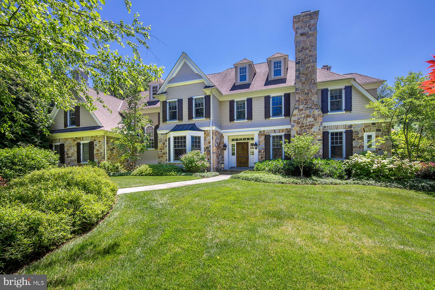 Find your bliss at this stunning Berwyn colonial by Pohlig Builders, crafted with quality, care and the highest level of finish. Stone pillars and a winding drive introduce a magical setting with lush trees and landscaping, and a beautiful stone and shingle gem waiting to spoil your family. Meticulously maintained and enveloped in privacy, the home has been the joy of its owners who raised their children here and made many thoughtful updates – from new appliances, windows, shingles, shutters & paint to refinished wood floors & other interior upgrades, replacement of most mechanicals, and installation of a generator.
Gorgeous grounds have been tended to by a passionate gardener with a focus on easy care perennials that provide color all summer long. From the magnolia tree with massive blossoms in the spring to the deep purple asters flowering in the fall, there is always something to enjoy in the park-like yard. This unique oasis affords peaceful, quiet environs with different outdoor areas for fun and entertaining, like a main patio with grill & outdoor speakers, sparkling pool with spa, side patio with outdoor fireplace, and expansive open grassy lawn in the rear.
The homes functional layout is ideal for daily living and hosting guests. A gracious entry hall welcomes you and leads to generous main rooms. Lounge in the living room around the fire, adjoined by a handsome library for the book lover and connected office for working remotely. Across the hall is a formal dining room with bay window, butlers pantry, Kountry Kraft & Pohlig kitchen with Wolf & Subzero appliances, new Bosch dishwashers, and an open breakfast room with doors to the patio and yard. The kitchen and family room with gas fireplace offer lots of space for cooking and spending evenings together or playing a family game. Also on this level is a well-organized mudroom with lockers and 2 powder rooms.
Serene sleeping quarters beckon upstairs, with 5 bedrooms and 4 baths on the second floor, highlighted by the luxurious master wing featuring a gas fireplace, dressing area, his/her closets, and spa bath with soaking tub, oversized shower and water closet. Another spacious bedroom with full bath & walk-in closet, and extensive storage reside on the finished third floor. The lower level is a great hangout spot for the kids with a computer area, game space with pool table & air hockey, and theater for movie nights & big-screen video games. Plus there is a 3-car attached garage with heater and detached 2-car garage with new WiFi-enabled garage door motors. Best of all is the location accessing the world-class TE School District and Episcopal Academy a few blocks away, close to 252, Whole Foods, Acme, King of Prussia Mall, and the airport.