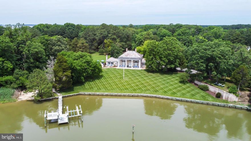 Prestigious Waterfront Home- Brick Georgian style colonial offers  extraordinary, quality construction.  Slate and copper roof,Impressive moldings, wood floors, finished basement recreation room, renovated custom top-of-the-line kitchen offers sub zero refrigerator, Wolf cooktop with griddle, 2 ovens, warming drawer, separate icemaker, and beverage refrigerator,  wet bar and waterside breakfast room. Large dining room with built-in corner cabinets overlooking Bolingbroke Creek and the Choptank River. Family room/ Den with wood burning fireplace, bay window and built-ins. First-floor owner's suite with new bathroom, marble floors, fireplace and walk-in closet. The second floor has wood floors throughout, four bedrooms and three full baths.  There is also a walk up attic for storage. The basement has bamboo floors, wainscoting, a pool table,and the extra finished room could be your exercise area.  Expansive water views, deepwater pier with lifts, private beach, inground pool and hot tub. Front and rear flagstone-covered patios with massive columns make this home one of the more notable homes in Talbot County. Lavish outdoor infinity pool with sun shelf, spa and flagstone hardscape.  Attached 2 car garage, paved  tree-lined circular driveway with plenty of parking. A long peninsula juts into Bolingbroke Creek offers sweeping panoramic views across Bolingbroke Creek to the Choptank River.  Deepwater pier with 2 lifts and special beach area for lounging or launching your kayaks.  Privately gated 8 plus acres and 2500 ft +/- of shoreline. Septic is approved for four bedrooms. You'll feel like you are on vacation everyday! There are too many details to list.  This is truly a must-see home!  Call for more information. Not in flood zone!!!