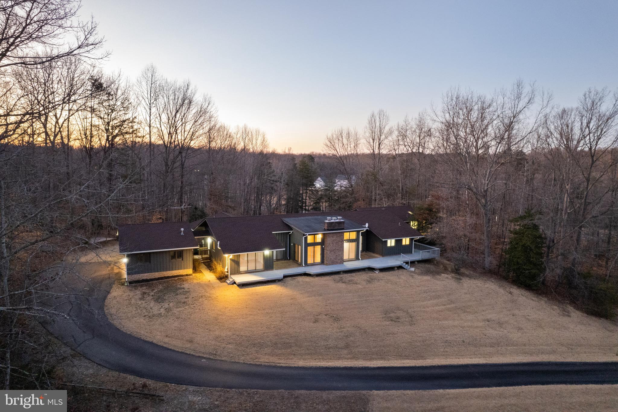 Sitting on almost six wooded acres, this beautiful custom-built home has 4-Bedrooms and a separate 3-Bedroom extension that can be used for extended family, a home office, and in-laws.
The main home features four generously-sized bedrooms and four beautifully renovated bathrooms. The master bedroom has his and her bathrooms and walk-in closets. A second bedroom/den has its own bath. A third and fourth bedroom with a new Jack and Jill bath are located at the other end of the home. The large eat-in kitchen has cherry cabinets with granite countertops. The spacious basement offers unlimited potential, featuring three multi-use rooms, a full bath, and three large storage areas, one of which includes workbenches and electrical outlets, perfect for hobbies or projects.
The separate extension with its own front entrance offers living room, breakfast and dining areas, three bedrooms, two full baths, a kitchen, and its own laundry room, providing a comfortable and private space. The extension is currently under renovation with new flooring, carpet, paint, etc.
For the aviation minded buyer, there is a private lighted and paved community runway.
Owner will finance qualified buyer at 5% with 30% down Radon and septic inspection reports are available. The best of both privacy and luxury in one of the most desirable locations.