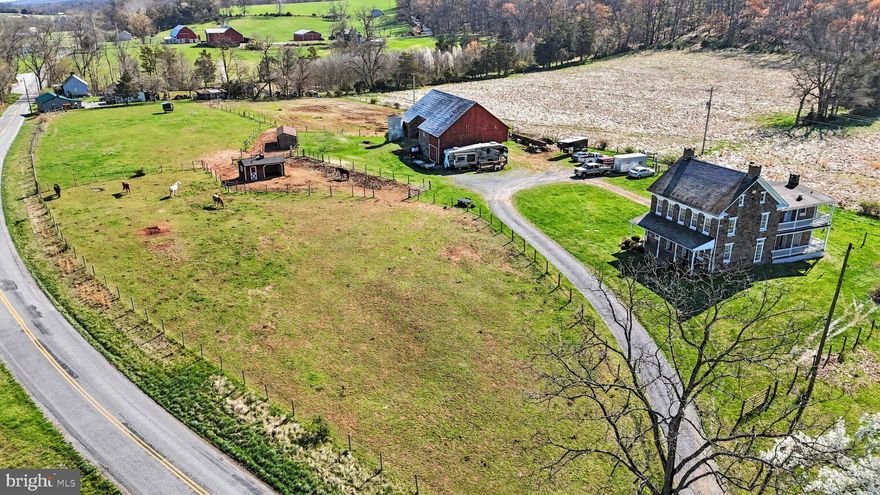 Nestled on 5 picturesque acres, this charming 1900s stone farmhouse blends timeless character with modern functionality, offering the perfect retreat for hobby farmers. Equestrians and hobby farmers alike will fall in love with the impressive bank barn, featuring 2-story stonework, 5 stalls, one being a pony stall, a workshop, a feed room, and a tack room. There is also great access from downstairs to upstairs with 2 hay drops and a staircase. The expansive upstairs level offers ample room for hay storage and tractor parking. A 40-amp breaker on the barn provides convenient trailer hookup capability for those trailers with living quarters. Water and electricity are already run to the barn and fields (including auto waterers and frost-free hydrants), making daily chores a breeze. The entire 5-acre property is enclosed with electric-coated wire fencing, providing security for animals and peace of mind for owners. Additional amenities include rabbit huts, chicken coops, and a dedicated outdoor riding area, making this property truly turnkey for the active farm lifestyle. Step inside this beautifully preserved 3-bedroom, 1.5-bath stone farmhouse, where history meets modern comfort. The home features the warmth and craftsmanship of its era, including stunning deep window sills that flood the space with natural light. The layout is as open and airy as a classic farmhouse allows, creating a natural flow between living spaces. The kitchen is anchored by a central island, perfect for gathering, entertaining, or farm-table dinners, and convenient second-floor laundry keeps everyday living easy and organized, while the mudroom allows for a semi-cleaner house. Enjoy the benefit of owning solar panels tied directly to the grid. No third-party company, no complicated leases — just clean energy savings working for you every day. This rare gem offers the charm of a century-old stone farmhouse with all the practical amenities a modern farm demands. Properties like this don't come along often. Schedule your private tour today!