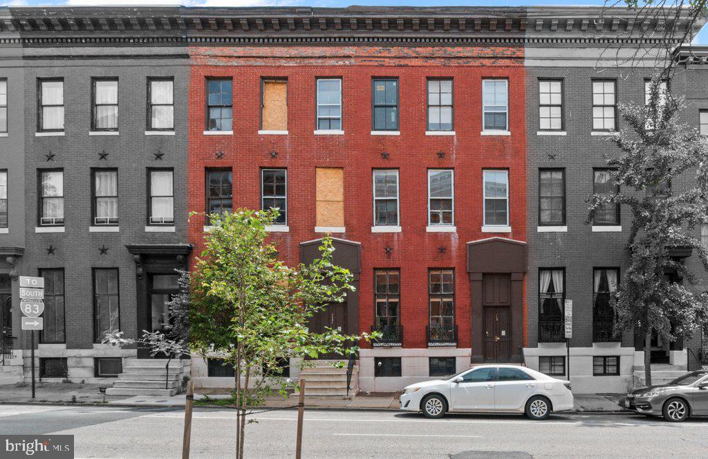 ● Offered at $700,000 — Just $58,333 per unit and $95 per sq. ft.
● 6 rented units + 6 gutted one-bedrooms — Fully licensed, separately metered units ready for redevelopment.
● $5,720 in current monthly rent — Offsets carrying costs while you plan your strategy.
● CHAP credit eligibility + tax assessment appeal — Reduce renovation costs with possible CHAP credits and reduce operating costs with a tax appeal.
937 North Calvert Interiors:
Kitchens are equipped with electric ranges. Four units have laminate countertops and wood cabinets; two have porcelain sinktops with metal cabinets. Bathrooms include steel tubs with ceramic tile or vinyl surrounds, along with and a mix of modern vanities or wall-mounted sinks. Wood windows run throughout the building, with walls finished in plaster or wood paneling. Ceilings are plaster, suspended grid, or Celotex. Apartment 2R has 9″ x 9″ tile in both the living area and kitchen; all other units feature a mix of laminate, parquet, and vinyl tile flooring.
939 North Calvert Interior:
Damaged by fire, 939 North Calvert has been fully gutted to the studs. The building shares a similar footprint and layout with 937, offering six pre-existing apartment units across three floors. Emergency shoring has been completed with new star bolts installed; per a prior engineering recommendation, the buyer may add additional anchoring to further stabilize the front wall. This work enables the preservation of the wall and positions the property for potential CHAP tax credits. Renovation of 939 North Calvert will require a full permitting process, installation of a sprinkler system, and a new Use & Occupancy certificate. This is a substantial redevelopment project and best suited for an experienced operator. Party walls include fire emergency doors connecting 939 to 937, providing necessary egress between the buildings.
Utilities and Mechanicals:
The buildings share a 400-amp electric service with 13 meters—one for each apartment plus a public service meter. Units in 937 have fuse panels and are individually metered, with tenants holding their own BGE accounts. One gas meter serves each buildings. Heat for 937 is provided by a central Columbia steam boiler with radiator distribution. Hot water for 937 comes from a central 75-gallon gas-fired water heater. 939 has a steam boiler and a gas-fired water heater, neither of which are currently operational. Observable plumbing supply lines are copper; observable drain lines are steel or PVC.
What’s Great About This Half-Rented, Half-Shell Value-Add Opportunity in Mount Vernon?
Located in one of Baltimore’s most walkable and culturally rich neighborhoods, this 12-unit opportunity sits just blocks from Penn Station, with access to Amtrak, and MARC trains. Tenants are drawn to the area’s top-tier institutions—UB, MICA, Peabody—as well as museums, restaurants, and iconic performance venues like The Lyric and The Meyerhoff Symphony Hall. A Transit Score of 98 and year-round rental demand support long-term stability and above-average rents.
With six income-producing units generating $5,720/month, investors can offset holding costs while executing a phased renovation. The six-unit shell at 939 North Calvert shares a matching footprint and existing layout with 937 North Calvert, streamlining the redevelopment process. Fully renovated one-bedrooms are projected to lease at $1,500/month, with a stabilized ARV of $1,865,680. Buyers may also benefit from CHAP tax credits and can pursue a tax assessment appeal based on the current condition of 939, potentially reducing renovation and holding costs.
Cash flow, tax strategy, and long-term upside—this Mount Vernon asset is ready for a smart operator to unlock its full potential.