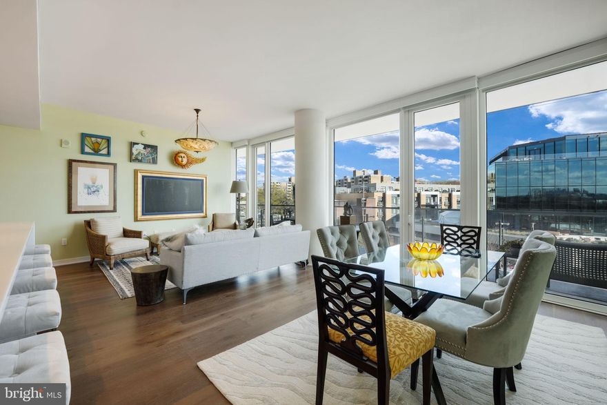 1ST TIME ON THE MARKET. Stunning 2 bedroom, 2.5 bathroom residence at The Wharf’s premier, full-service community The Amaris. Designed by world-renowned architect Rafael Viñoly, #402 offers over 1,600SF of unparalleled contemporary design from the moment you enter the home from a private in-unit elevator and are greeted by floor-to-ceiling windows offering Potomac River views from every room. An open living & dining area entrees to the large, curved 6' deep (310 SF) balcony providing sunrises & sunsets year-round, vistas over the Wharf Marina to Hains Point and East Potomac Golf Course. Oversized kitchen with Stevali cabinets, honed marble countertops, a full-height marble backsplash, fluted & lighted glass cabinets, a waterfall-edge oversized island, and cabinet-front Thermador and Bosch appliances. The primary suite offers a spa-like bath with a handsome stone floating dual vanity, custom Robern mirrored cabinets, soaking tub, and glass-enclosed shower as well as programmable Toto water closet, while the primary offers custom built-in closeting. The second bedroom suite, separated from the primary by the common area, is perfect for a guest, home office or den, and has a sumptuous bath with floating vanity and separate shower. Additionally, #402 offers an elegant powder room (rare in The Amaris), a walk-in laundry room with a utility sink, copious amounts of in-unit storage, custom lighting, and wide-plank European oak flooring throughout. To complete this perfect offering are two secure, side-by-side garage parking spaces (one with an EV hookup - an upgrade no longer available in the building) within feet of your private elevator entry, as well as an additional private storage. The Amaris redefines luxury living with an exclusive collection of world-class amenities designed for comfort, wellness, and entertainment. An indoor, unparalleled saltwater lap pool and hot tub is adjacent to the community's sauna, steam room, and private treatment rooms. The state-of-the-art fitness center is equipped with private training/yoga studios and professional equipment. A community lounge provides reservable space for social events as well as a screening room provides business or entertaining. Additionally, there is a large building-accessed terrace with a serving bar, kitchen, seating areas, fire pits, and lounge. The Amaris retains concierge service, newspaper & package delivery, valet, a dedicated porter, and a full-time front desk staff, among other services. 601 Wharf is an address with world-renowned restaurants, exclusive shopping, live music venues, and marinas all in a setting unlike anything else in DC...and #402 is the perfect marriage of the best of everything both inside and outside your home's front door.